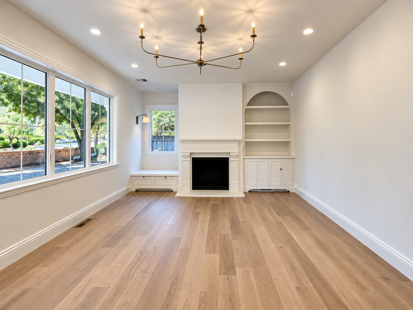 Light-filled living room with wood flooring, a fireplace, and built-in shelving.