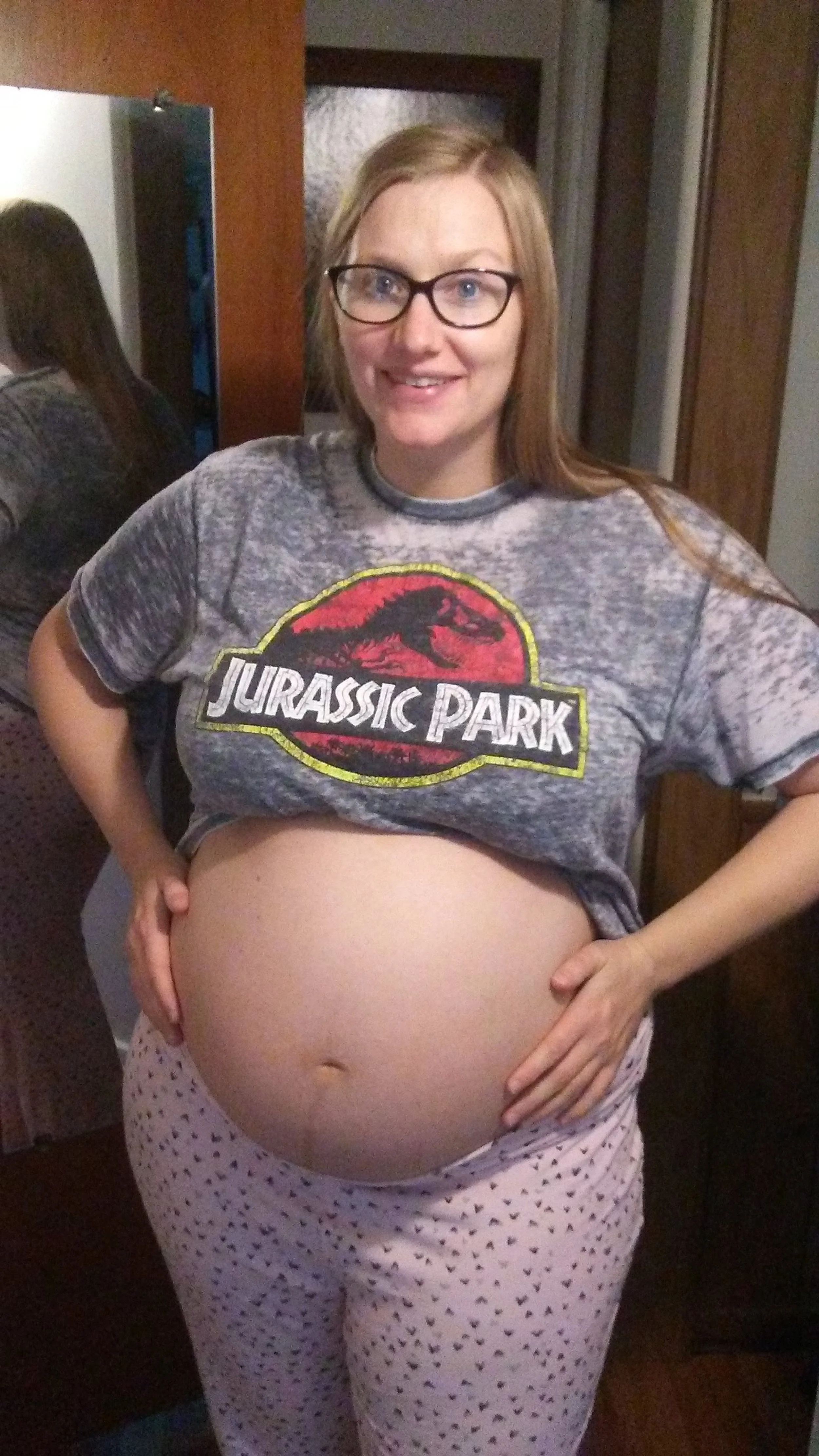 Sarah Austin pregnant sporting a shirt from one of her favorite movies, Jurassic Park.