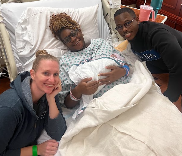 Birth Doula Sarah Austin at Anne Arundel Medical Center with birth doula clients holding their newborn.