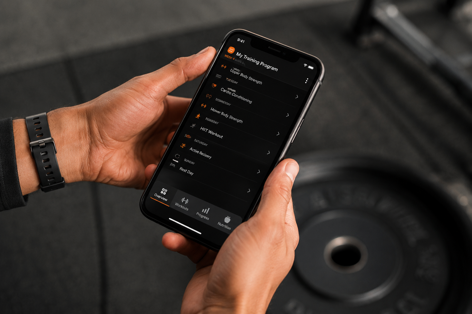 phone screen held in hands with fitness training program