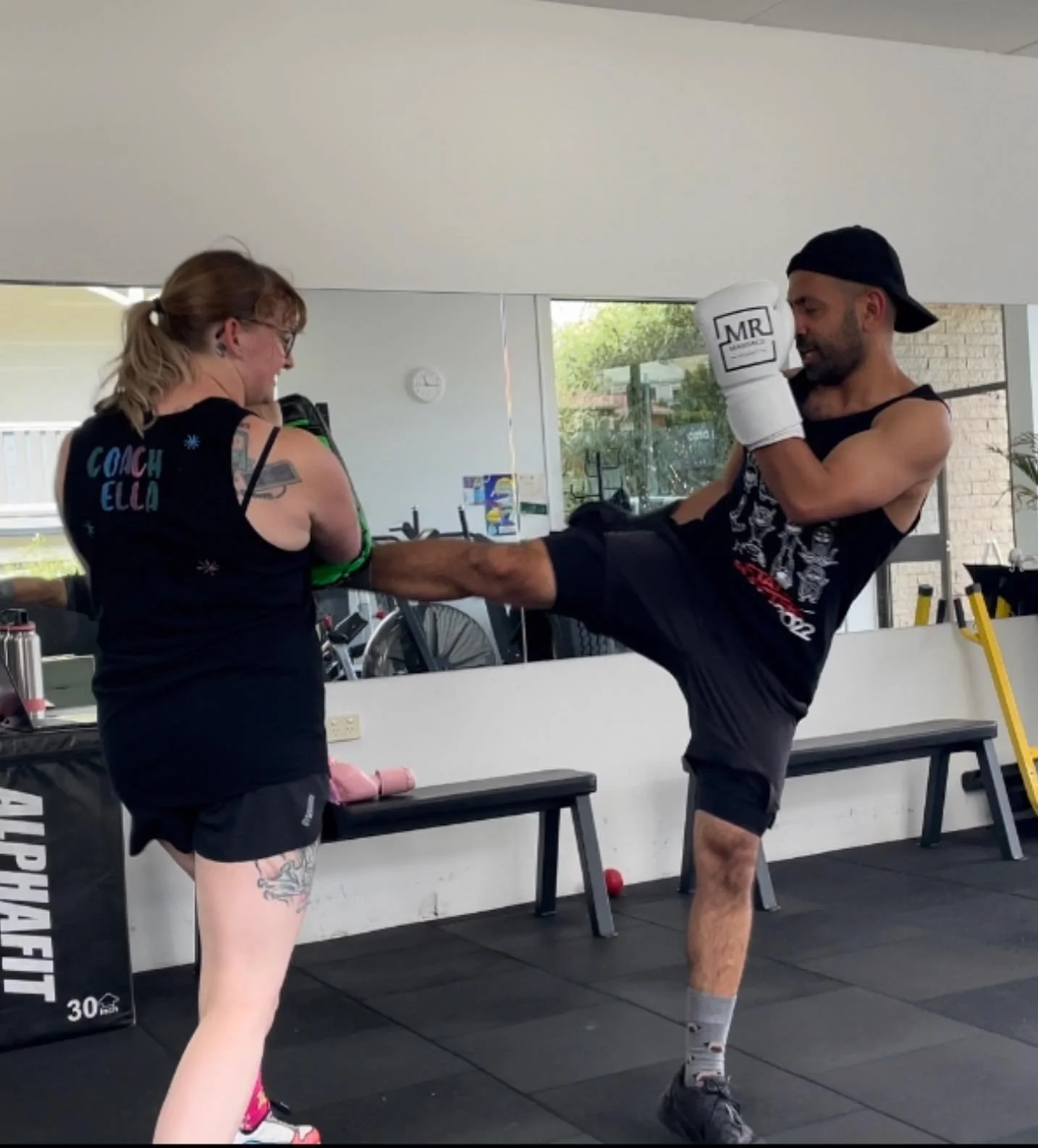 coach shani mirza boxing with white gloves