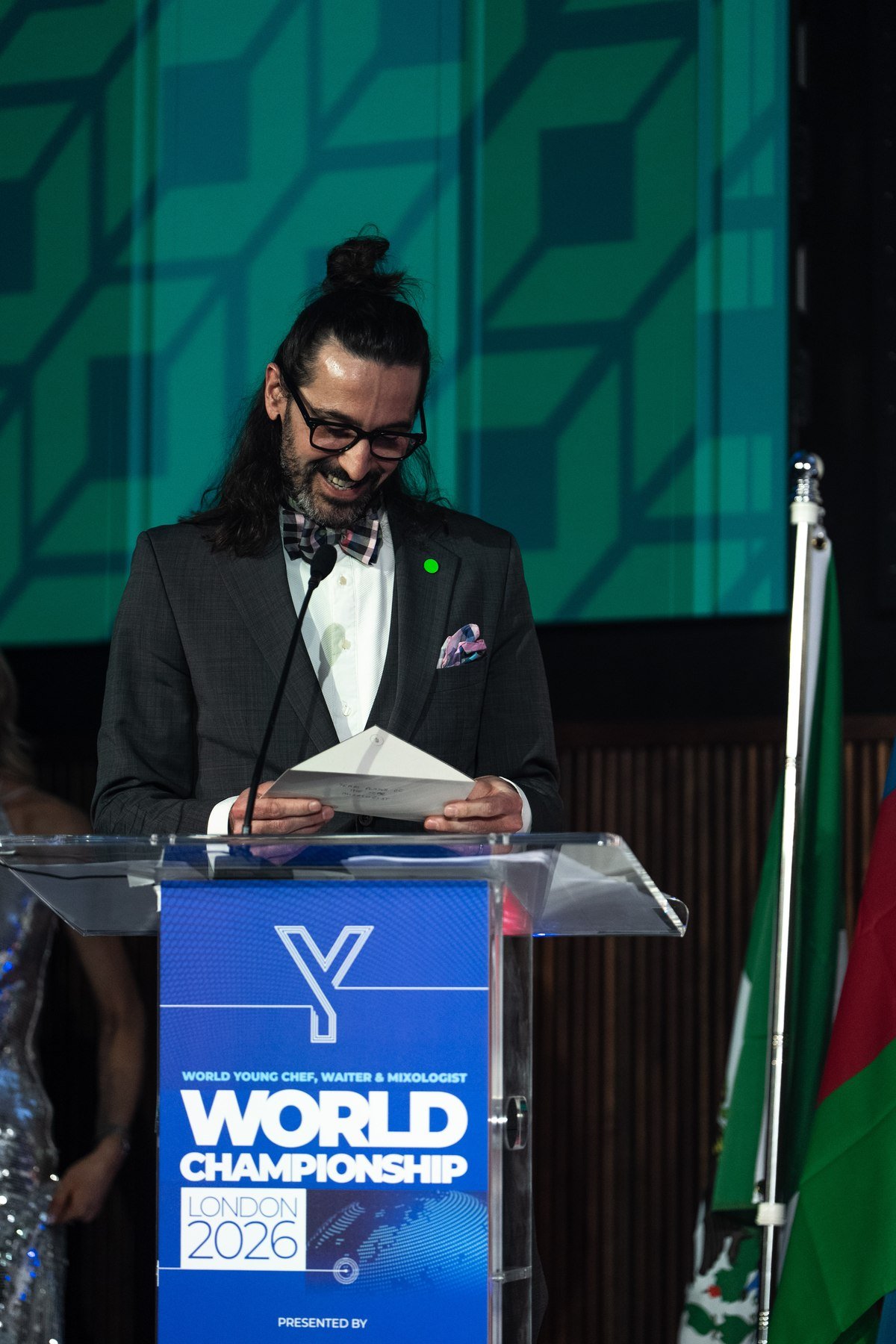 Matthias presenting at the podium at the World Young Chef, Waiter & Mixologist Championship, London 2026