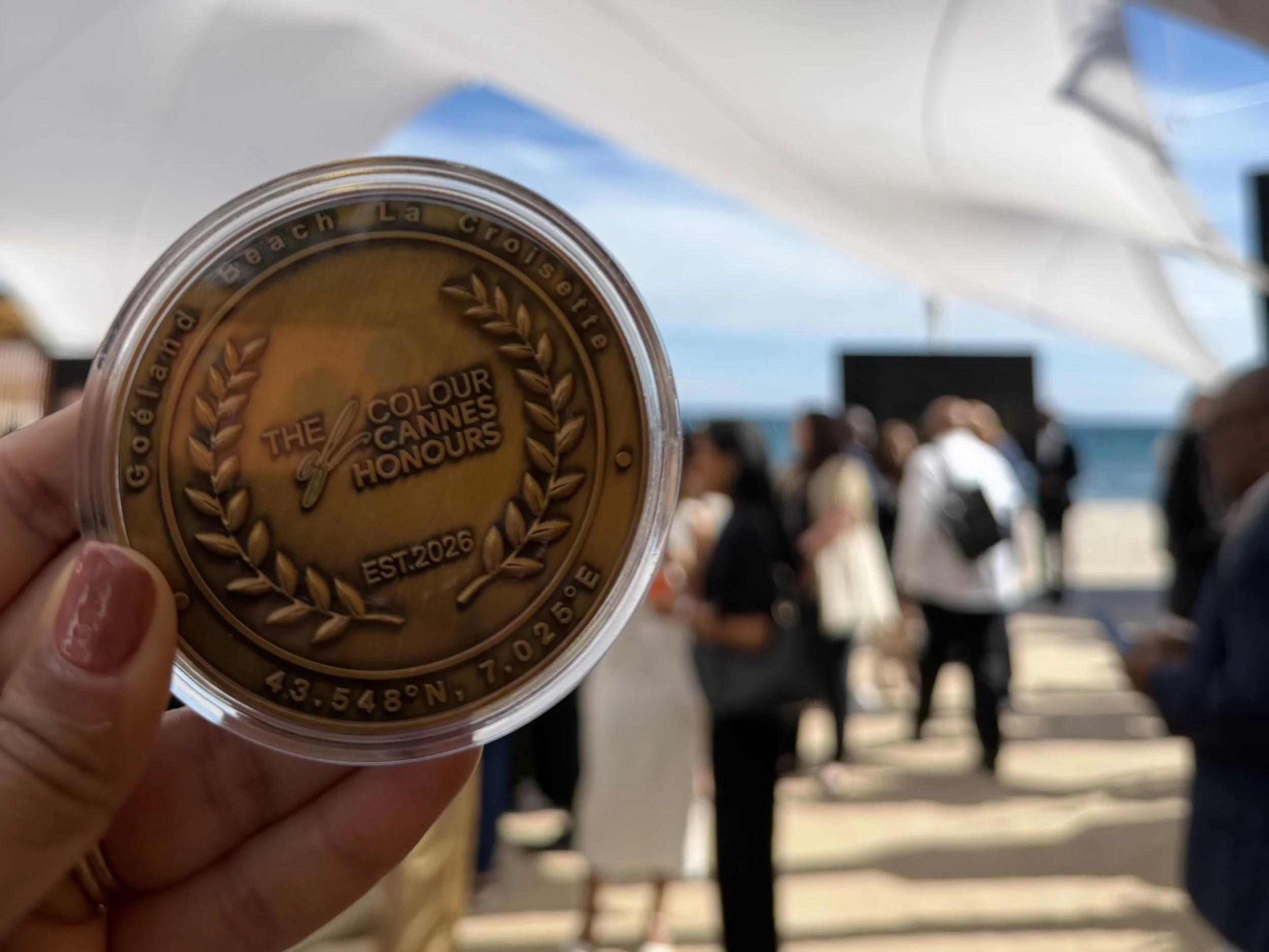 Bronze medal showing "The Colour of Cannes Honours" with laurel wreaths and coordinates