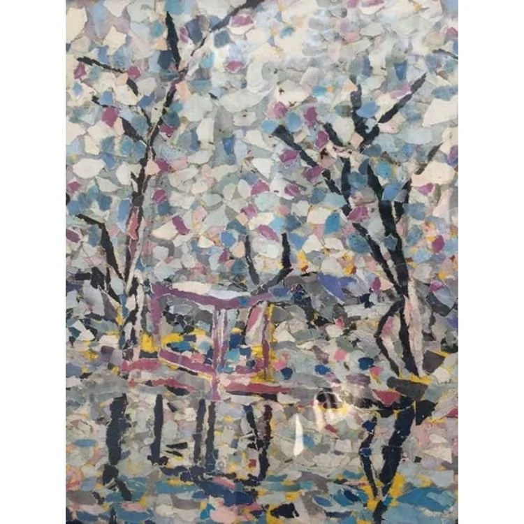 artwork made up of cut up magazines to make a colour library and form a picture of a lake setting