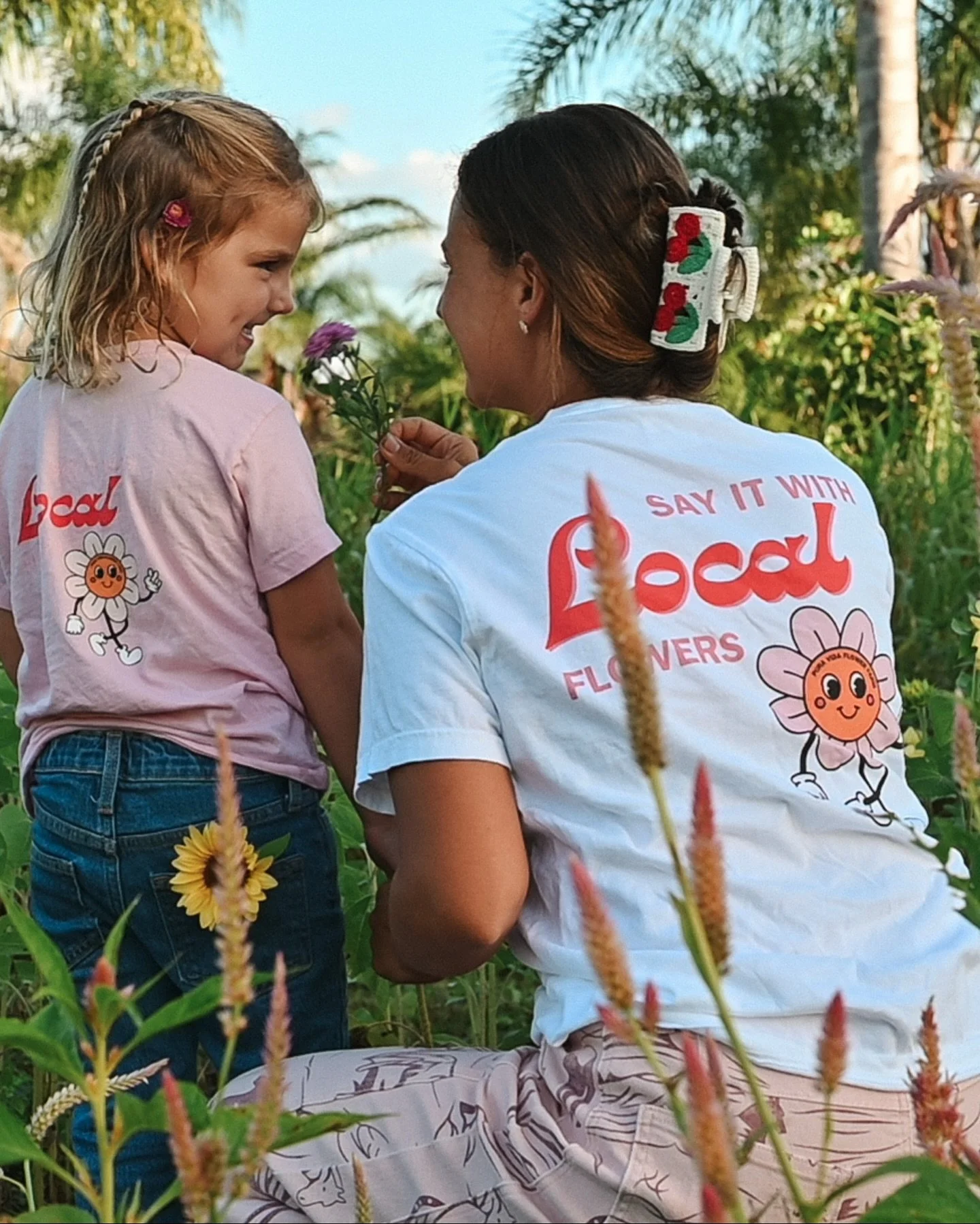 For you &amp; your littlest buds 😉🌸 next up in sharing Pura Vida Merch: our Say It With Local Flowers Tee! Available in all sizes and lots of colors. We love these tees at our house and we hope you do too! How blessed are we with all these models?!