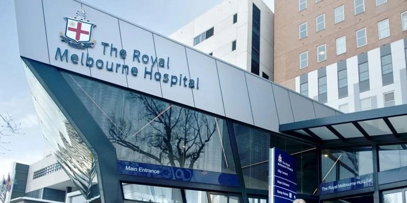 Exterior view of The Royal Melbourne Hospital building with signage indicating the main entrance.