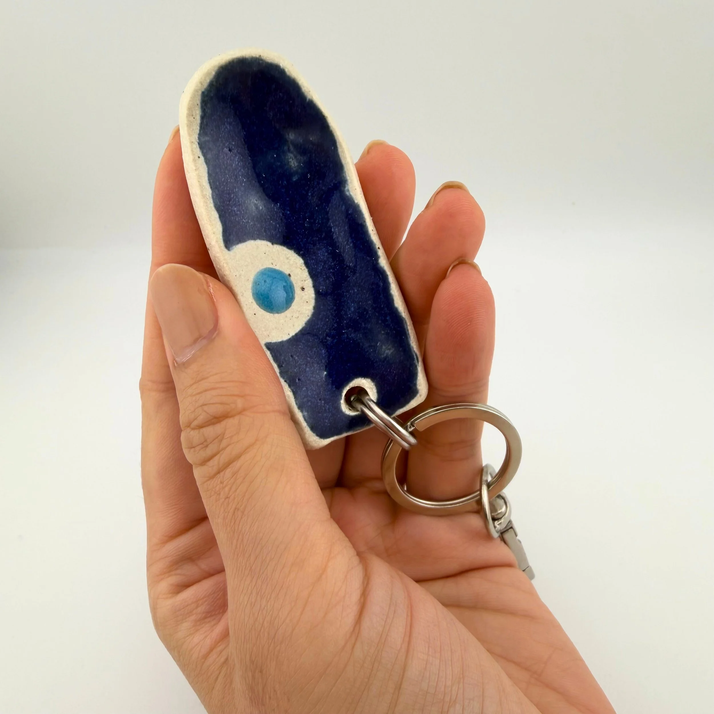 calmware-worry-less-stone-keychain-large-evil-eye-in-use.jpg