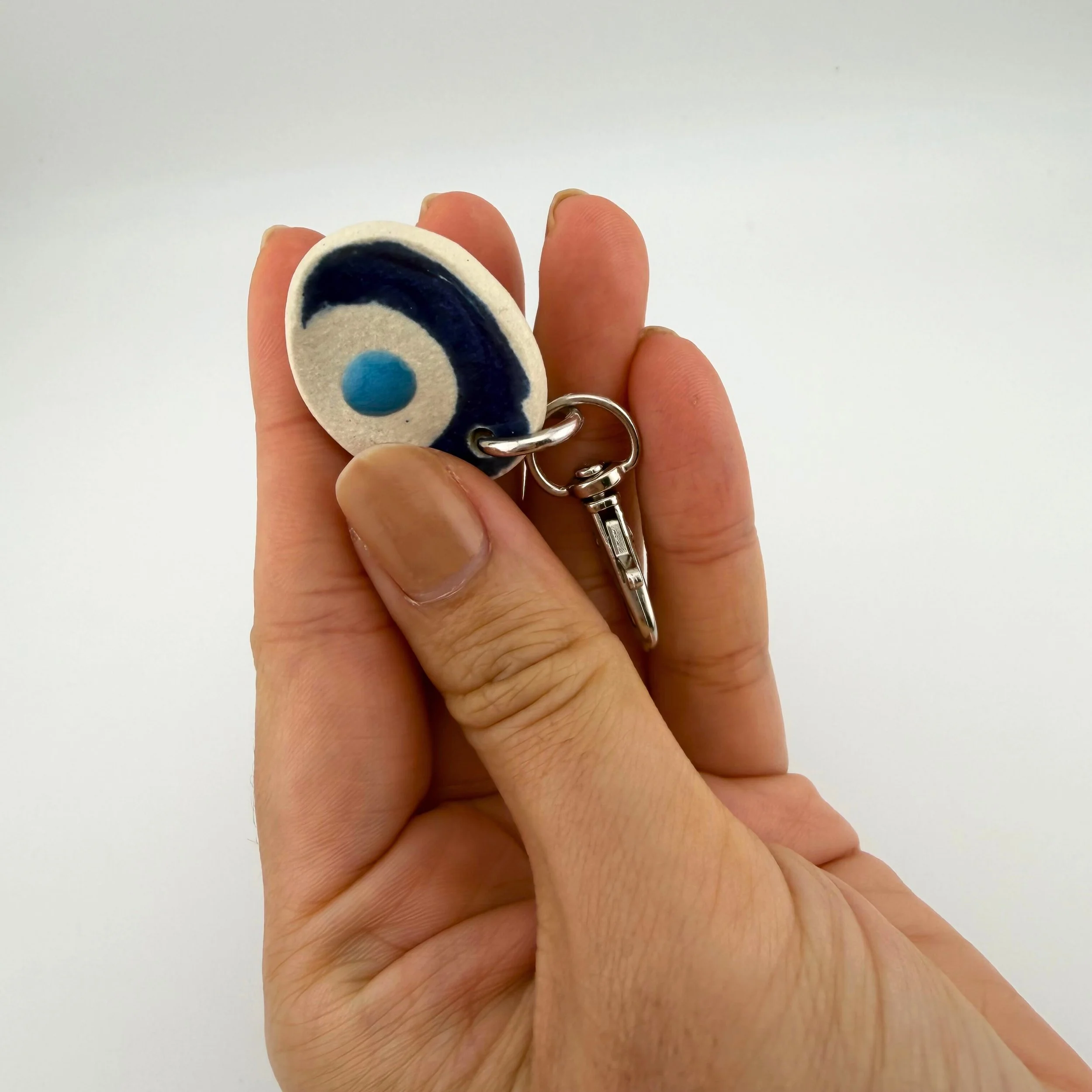 calmware-worry-less-stone-keychain-small-evil-eye-in-use.jpg