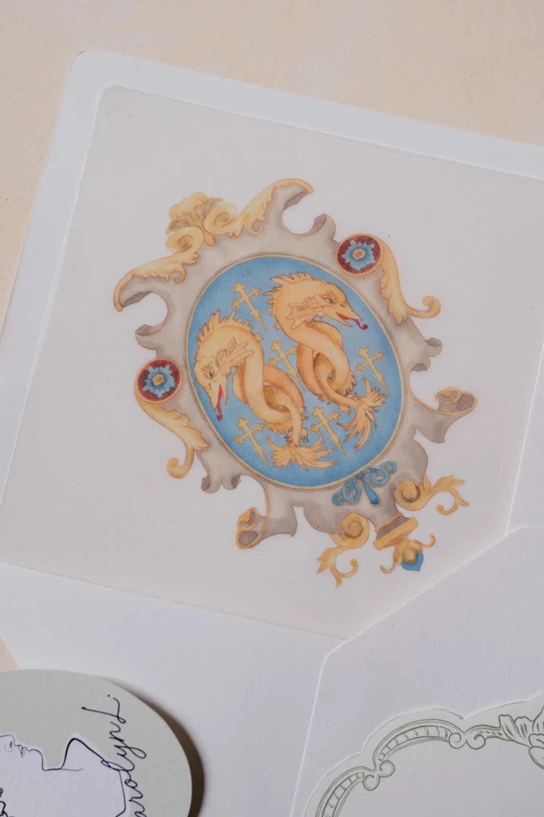 Decorative crest featuring two golden dragon-like serpents with multiple crosses, set against a blue background with ornate gold and beige scrollwork.