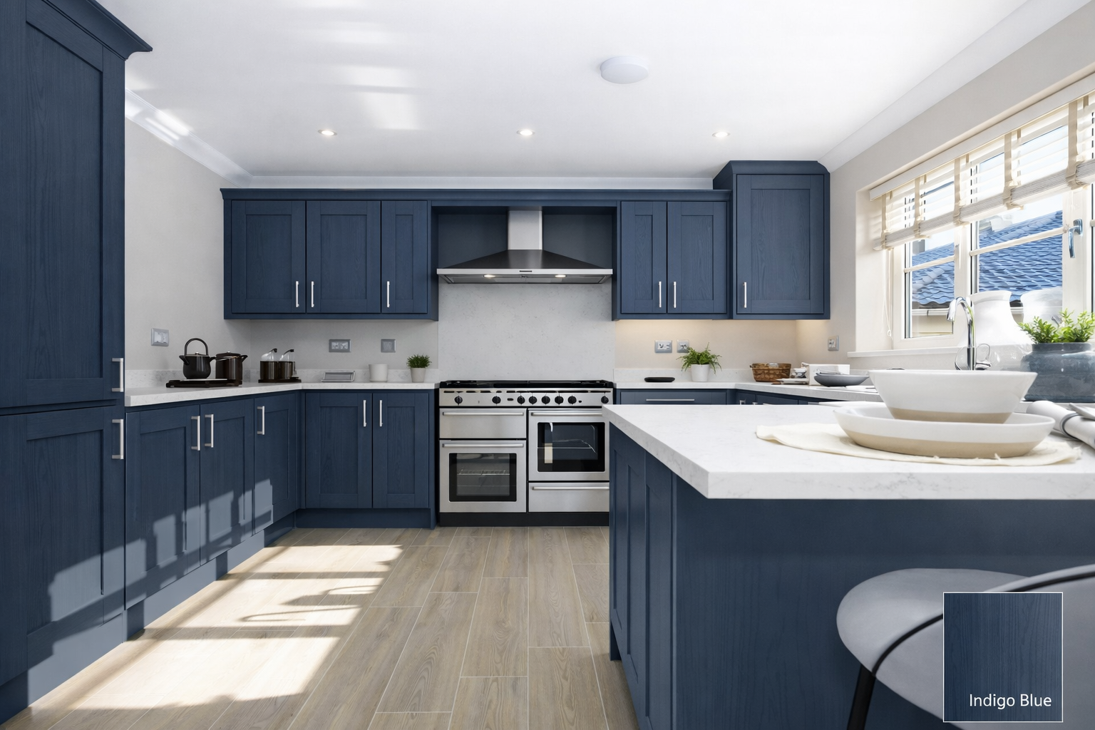 Modern kitchen with navy blue cabinets, stainless steel appliances, white countertops, and a large window with blinds overlooking a tiled roof.