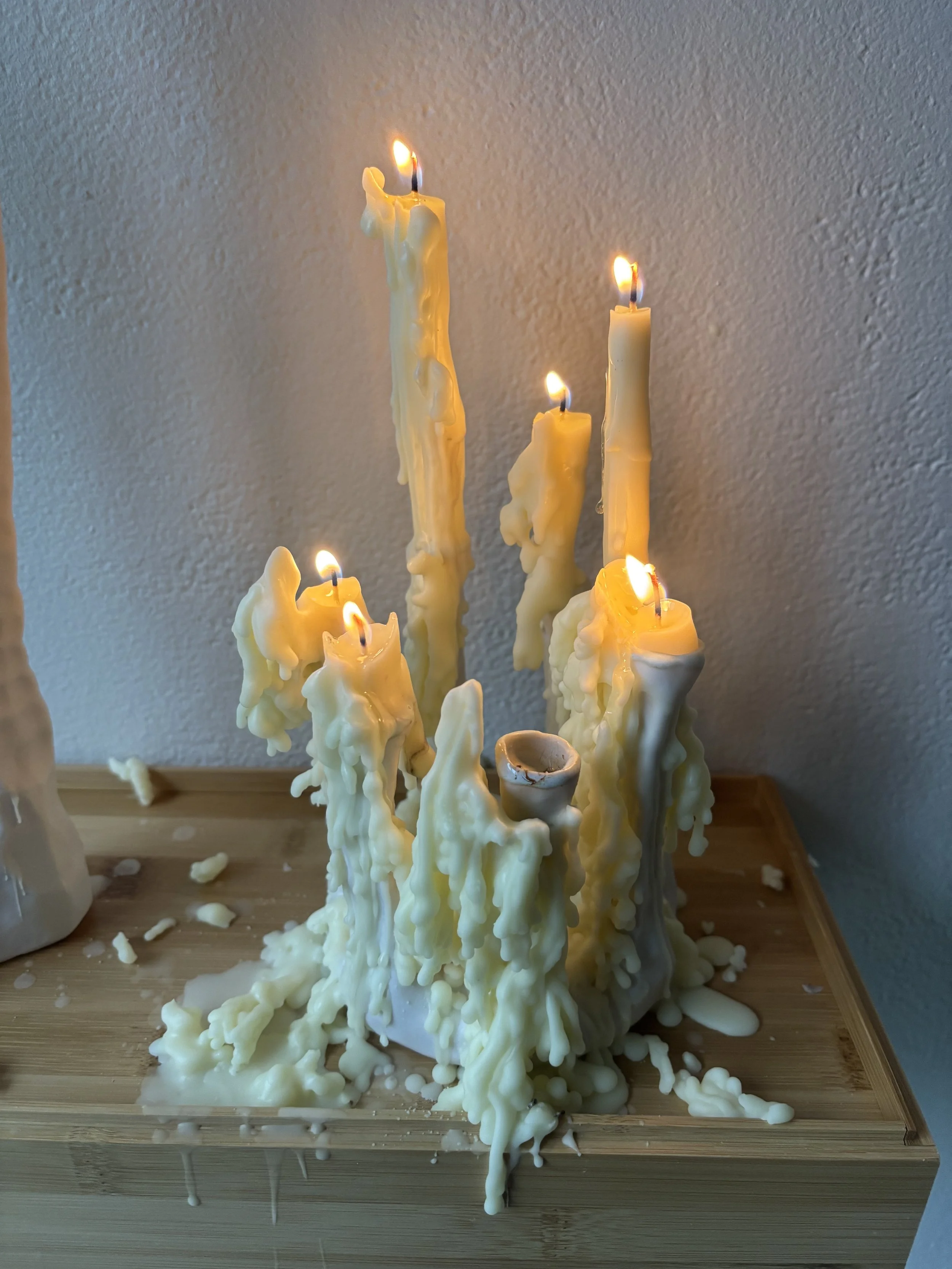 "Wax Memories," ceramic, beeswax candles, flame, 2024