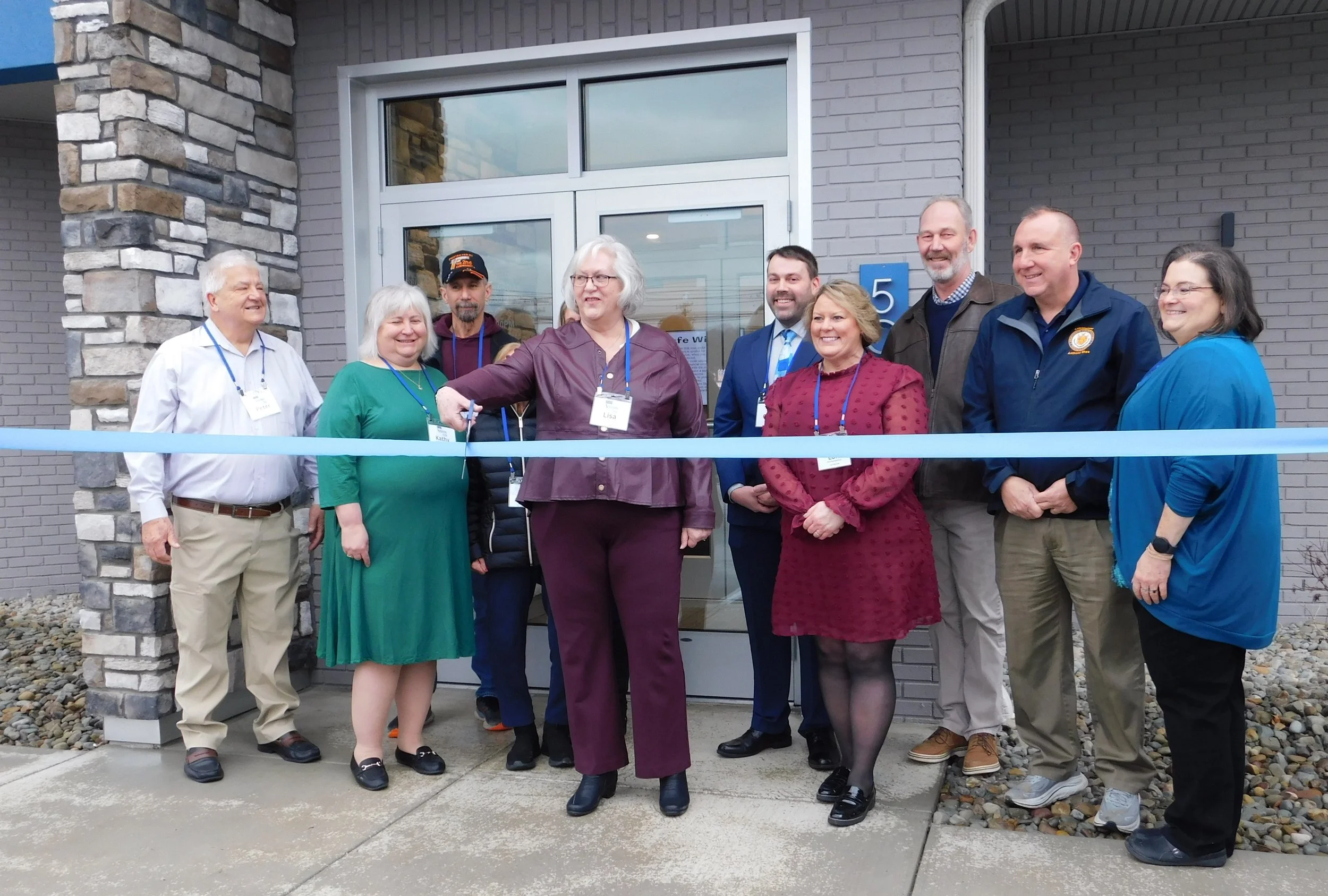 AAFCU Board of Directors, Management Team, Brett Ligo, Ligo Architects, and Commissioner Anthony Shea at our Ribbon Cutting, January 12, 2026.