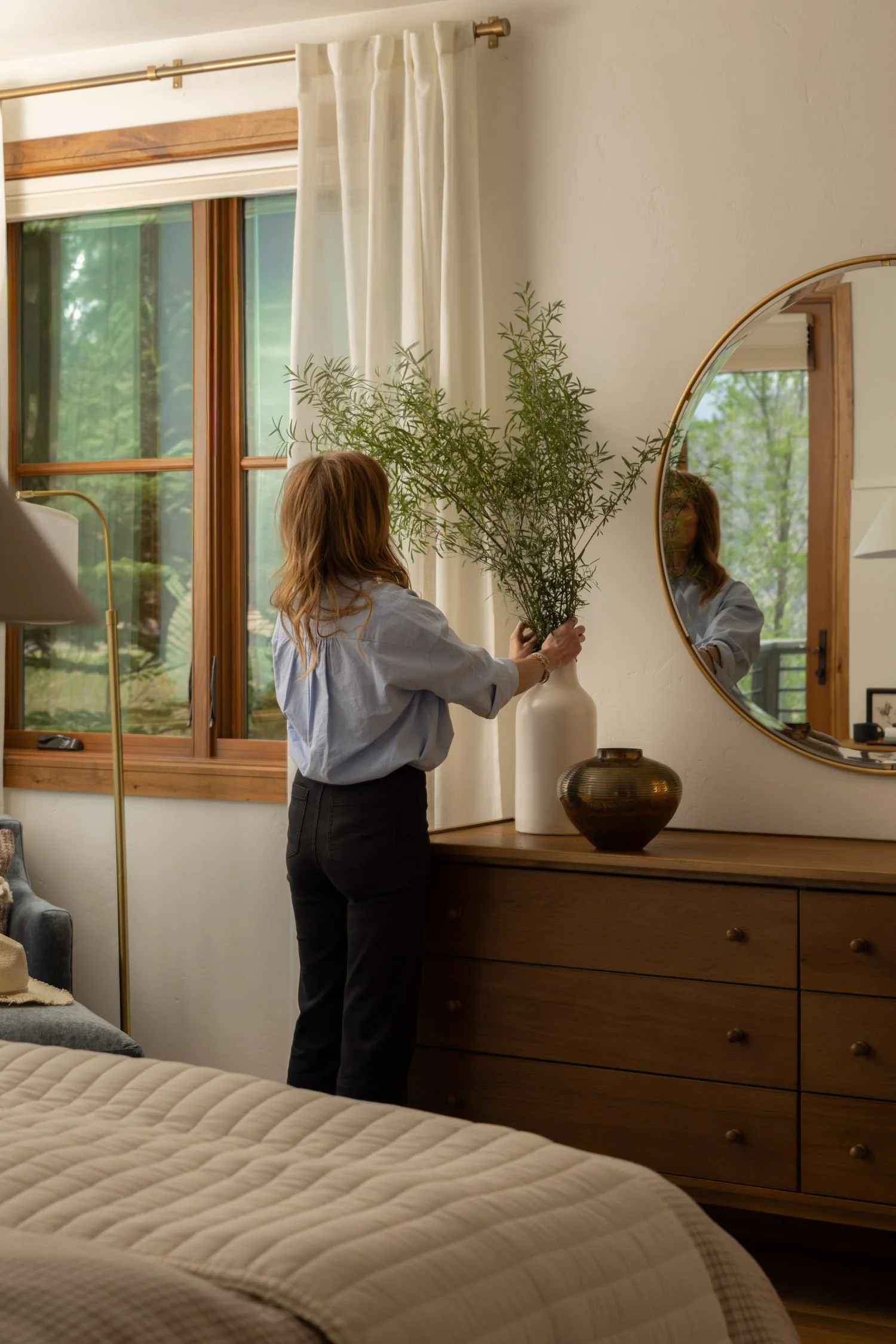 Interior designer Krista Weisman arranging flowers in a warm, modern Vail home