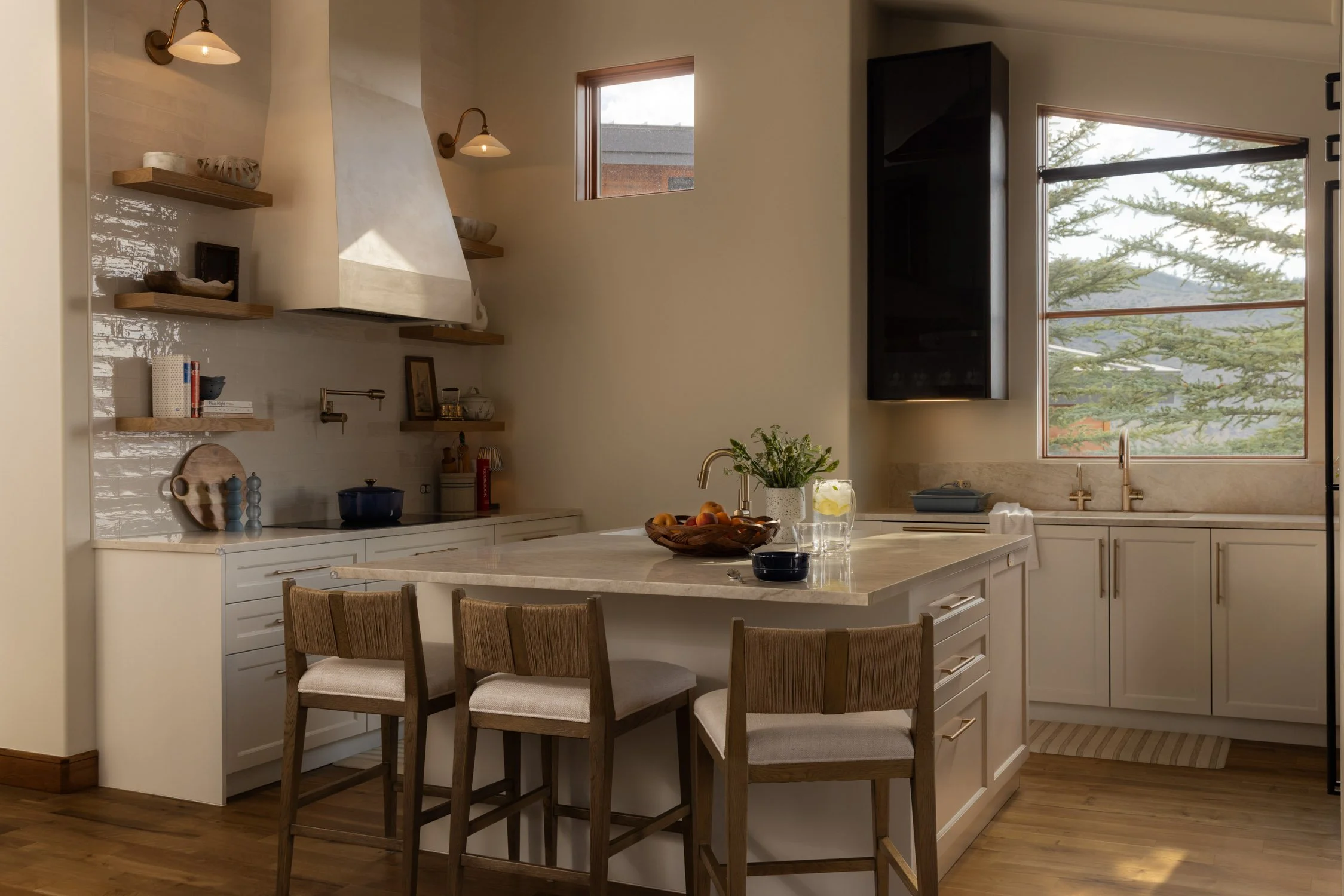 Vail Valley kitchen with white cabinets, granite counters and white tile backsplash by interior designer Krista Weisman