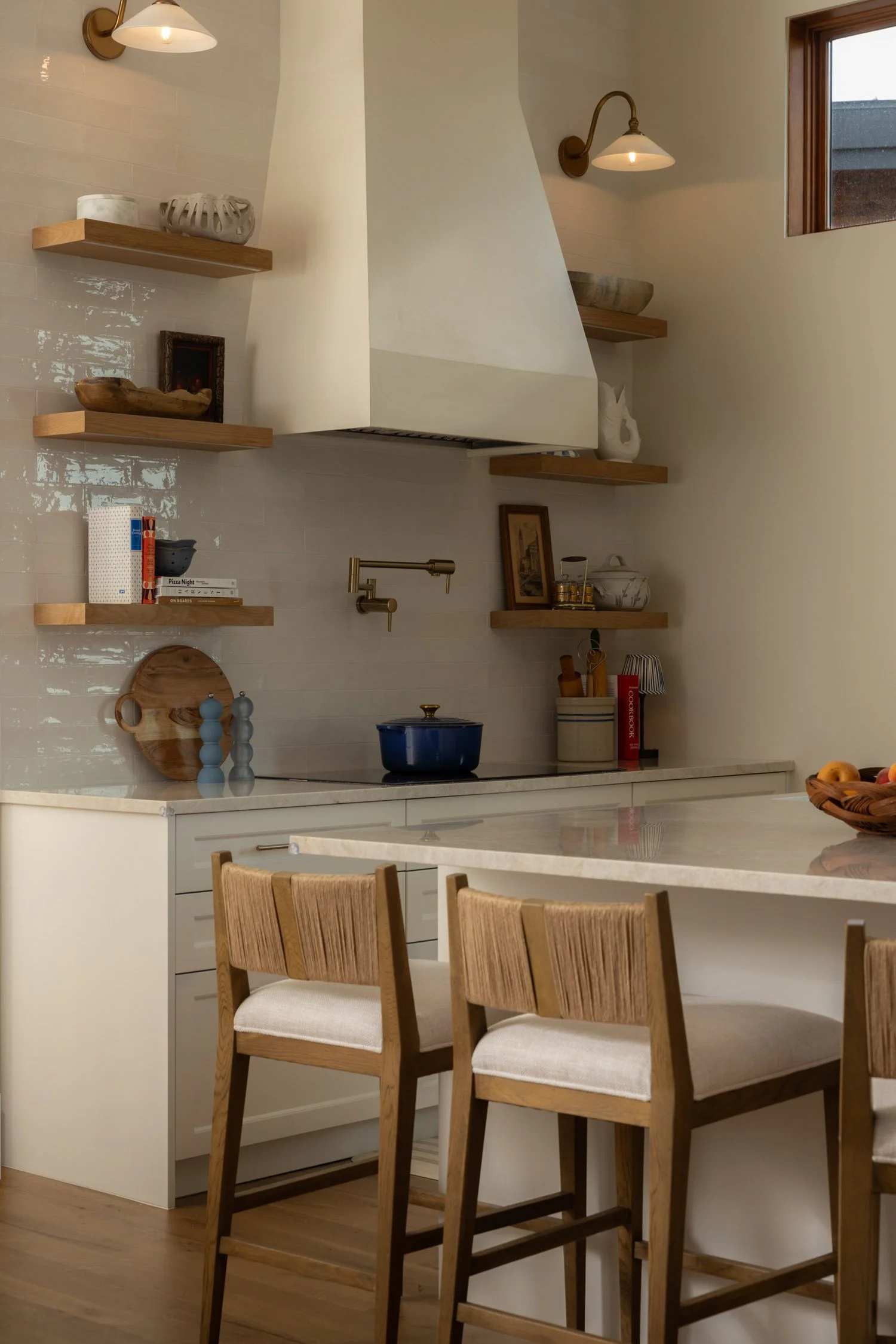 Vail kitchen design with white tile, kitchen island, and bar seating designed by Intentional Design Co.