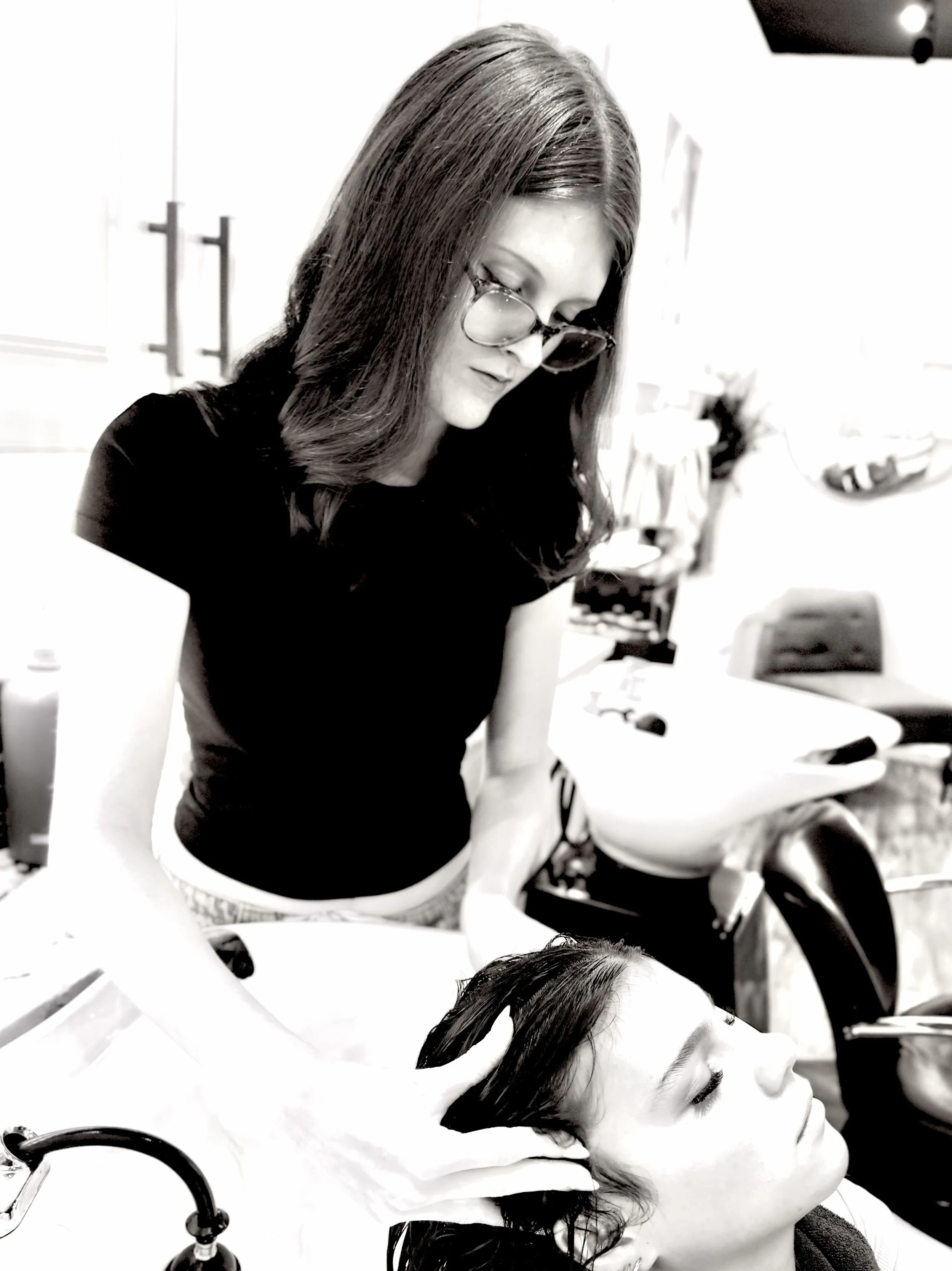 Nora Reid, woman massaging scalp of salon guest