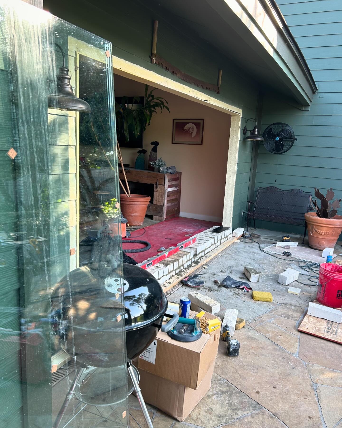 We changed two old doors to a large window to see the beautiful view of the yard from the living room, We also made a stone step to place the glass on. The owner wanted to add a touch of rustic style. Now the owners can enjoy a nice coffee with a won