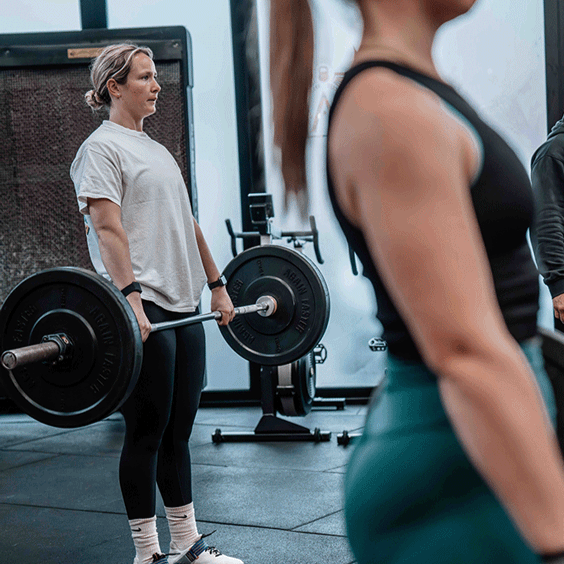 Two women weightlifting in a crossfit gym Beckenham