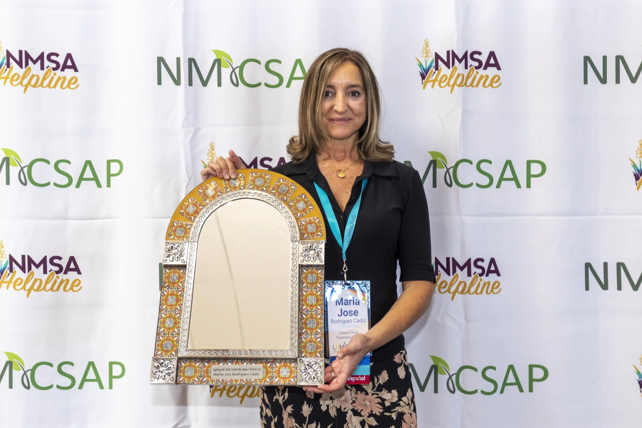 A women posing with an award