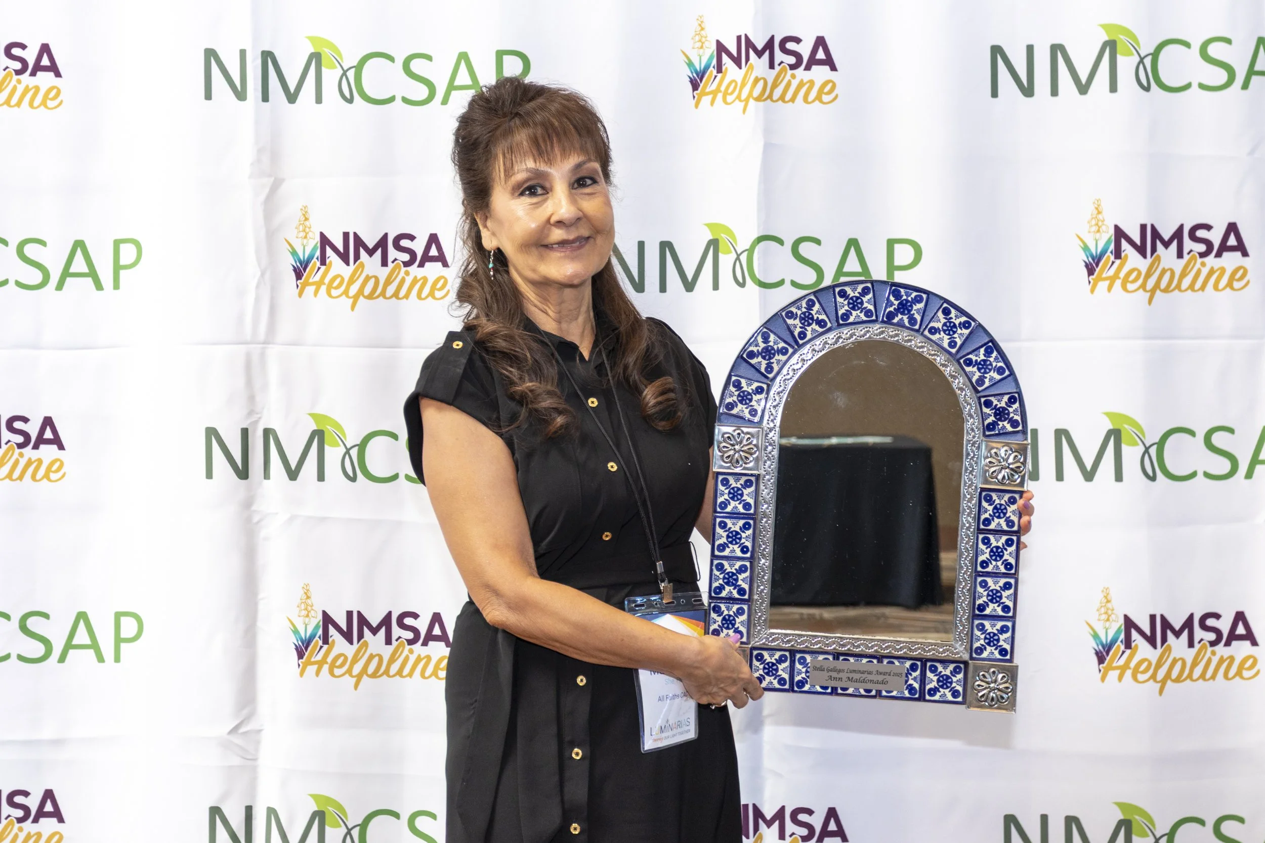 A woman posing with an award