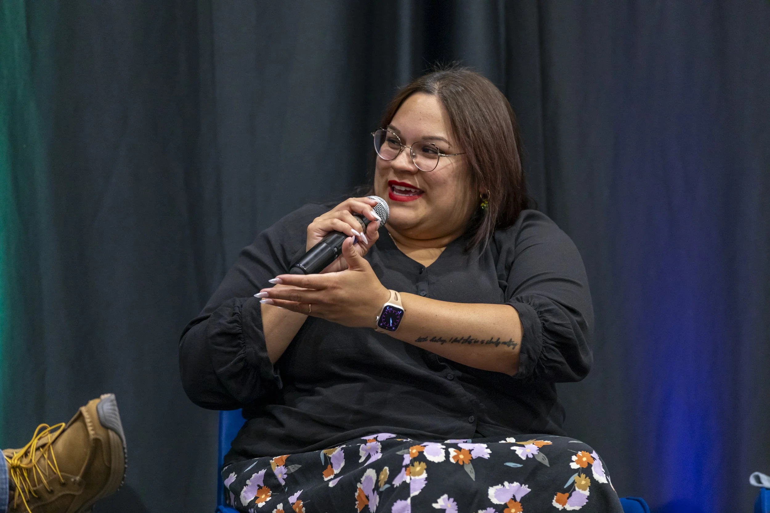 A woman speaking into a mic