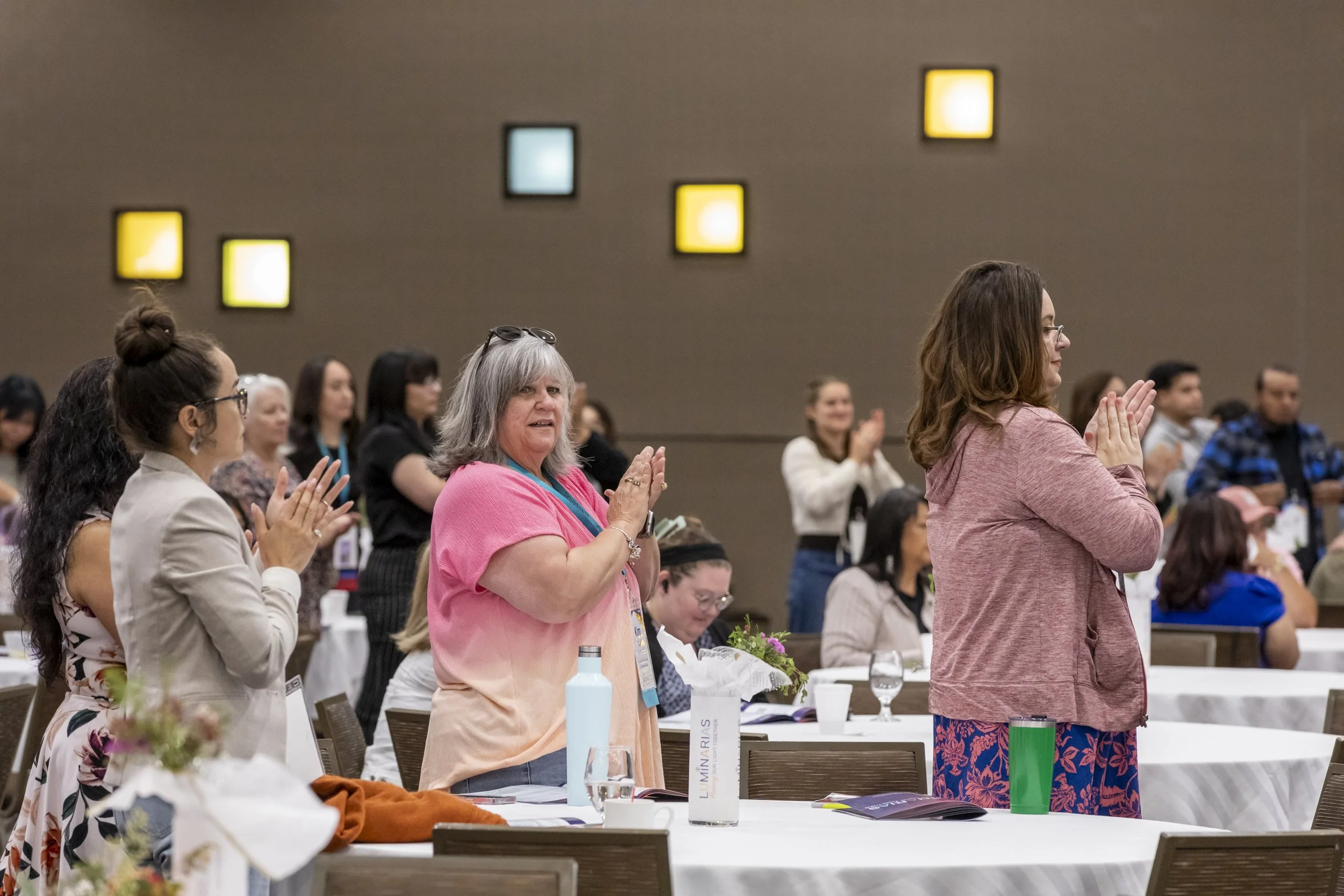 People standing and clapping