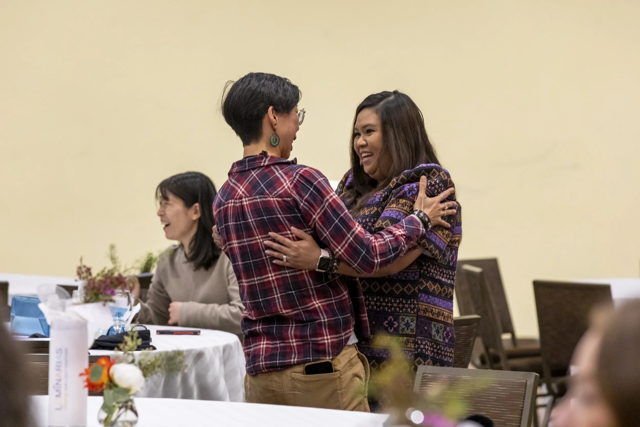 Two people embracing and talking