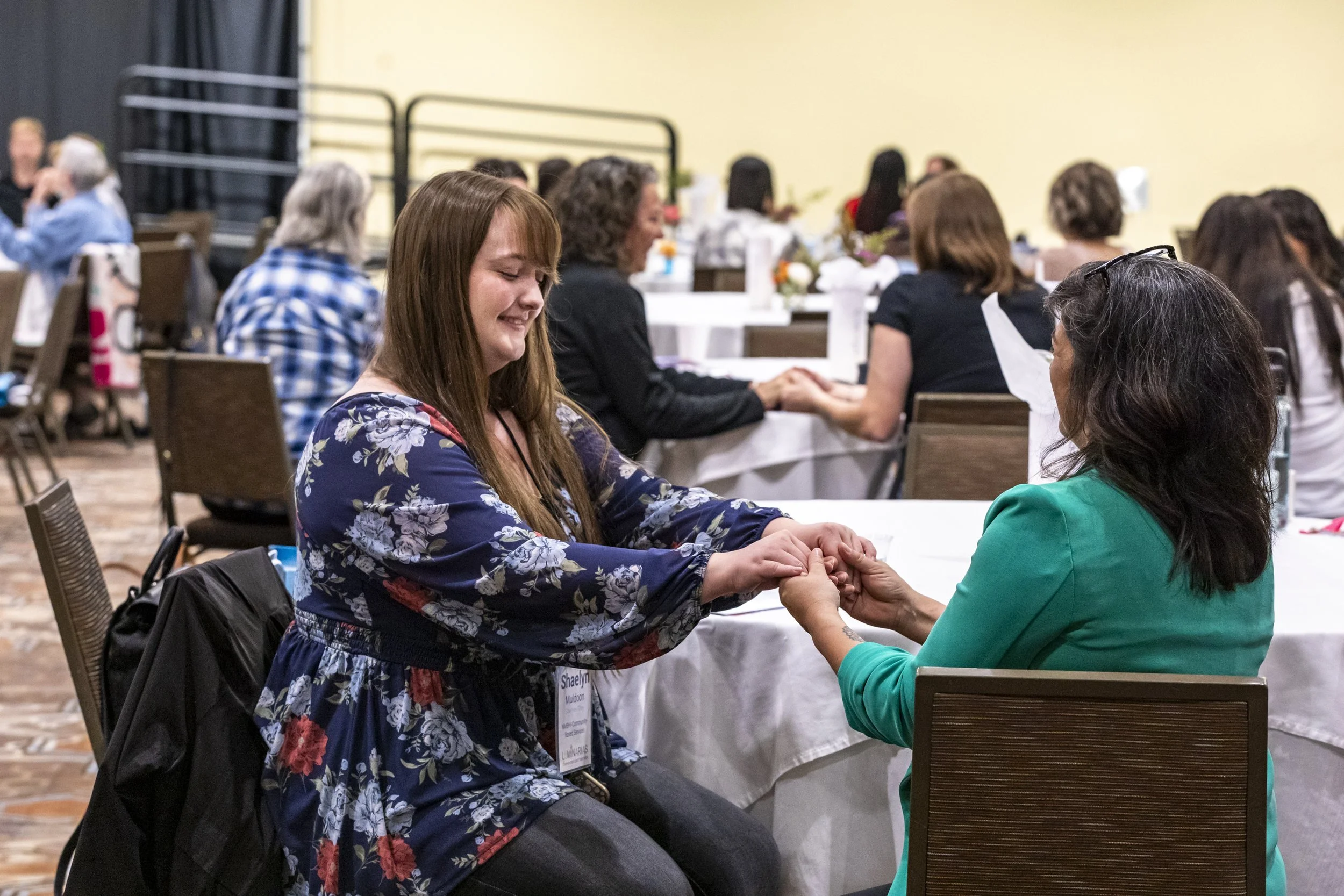 Two people holding hands at a table