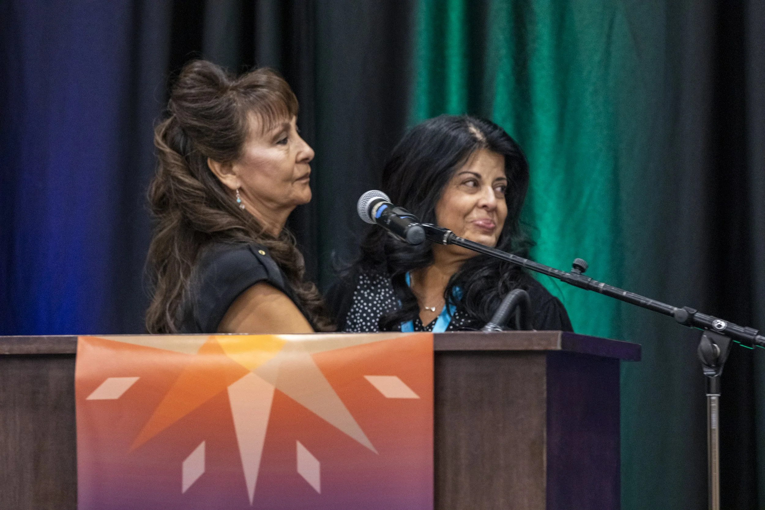 Two women standing behind a podium