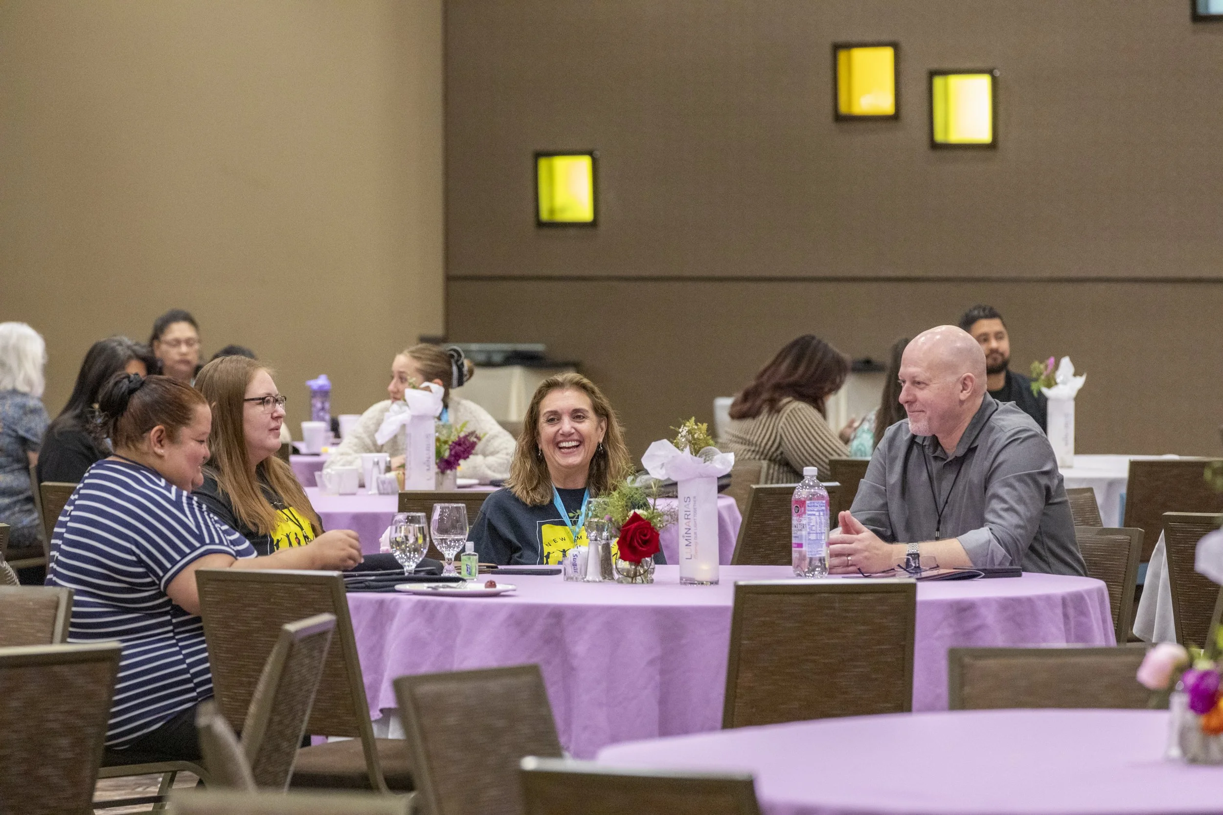 A group of people talking at a table