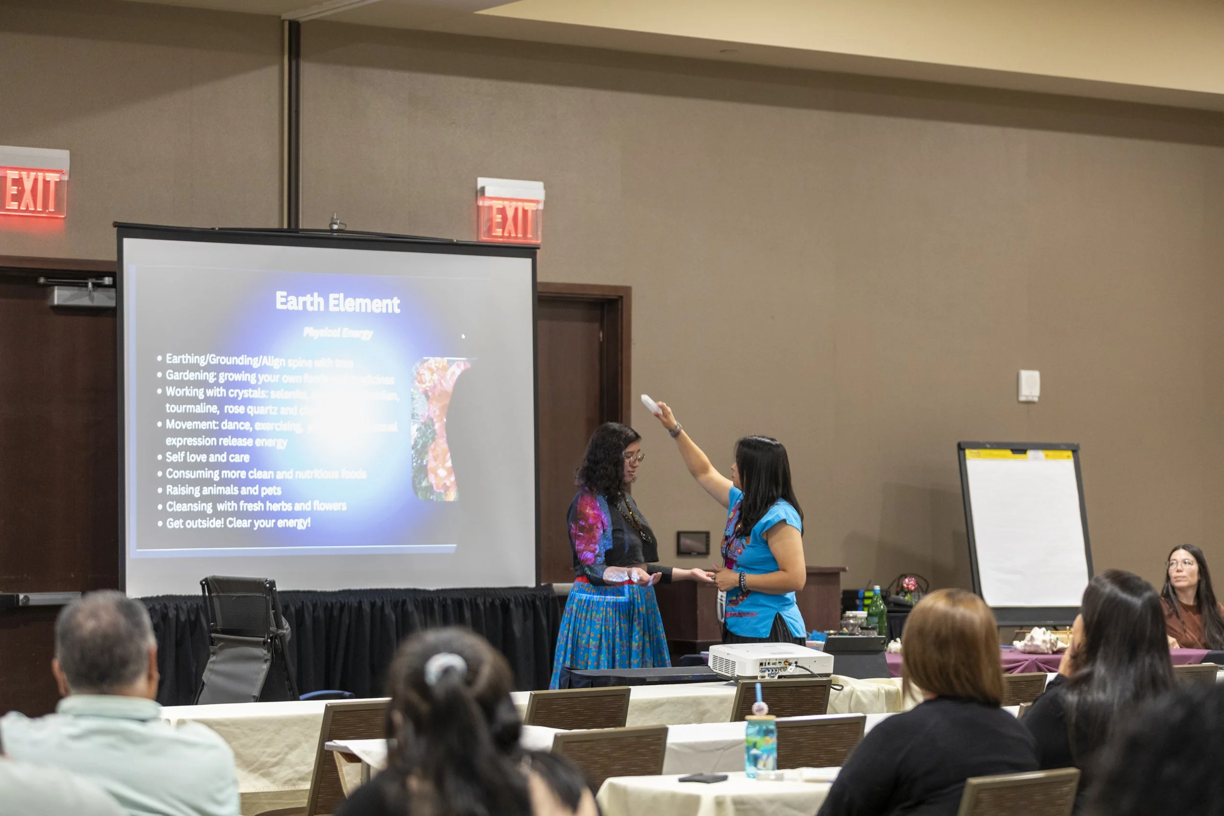A person demonstrating a healing exercise with another