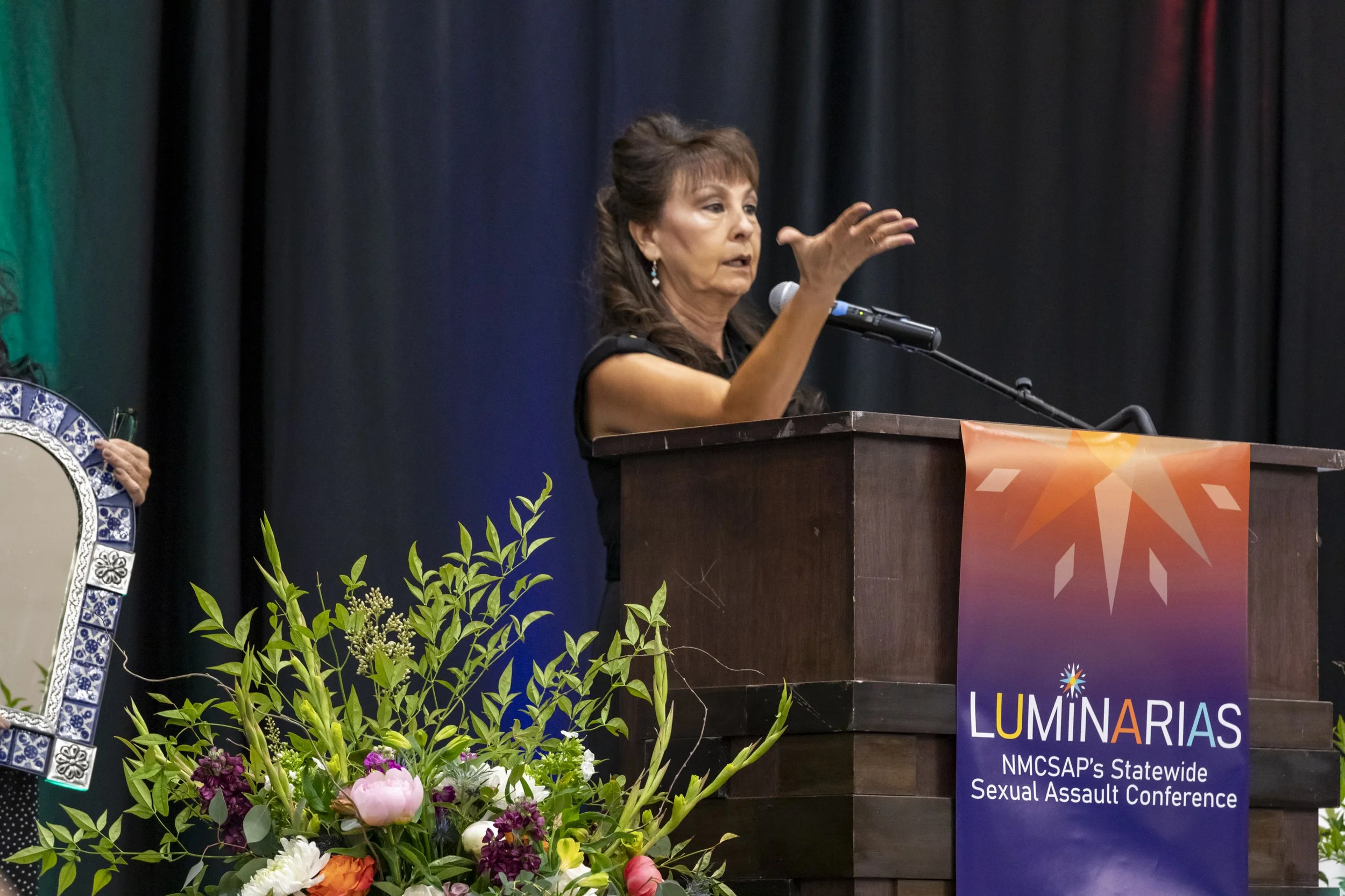 A woman speaking at the podium