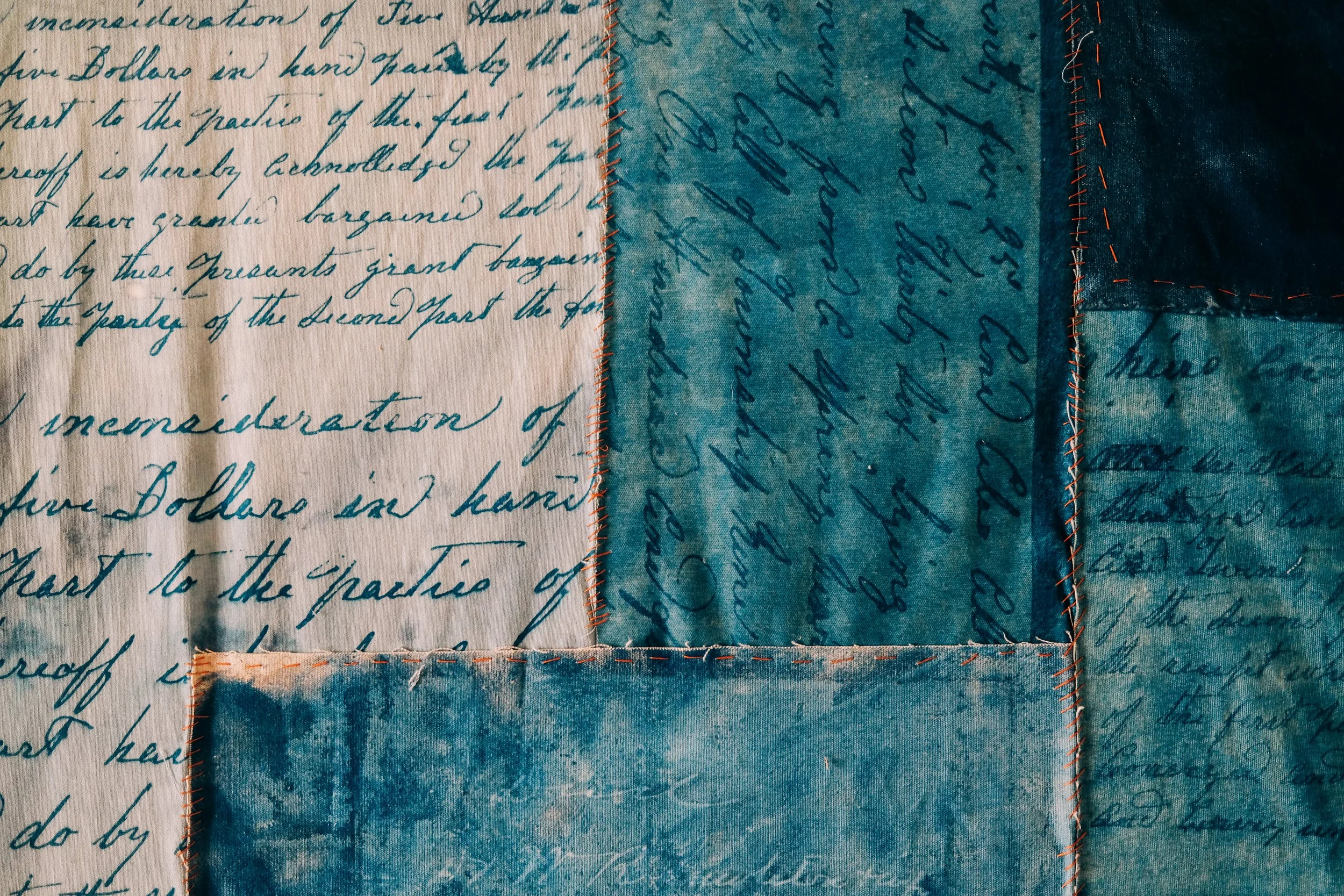 The Baker Family land deed from 1879 was made into a cyanotype and stitched together using fabric from Project Threadways.