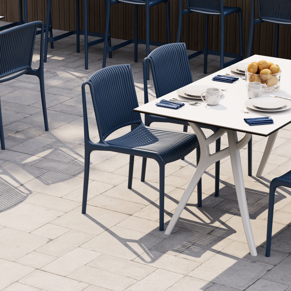 NES Chair Sax Blue sitting around a table