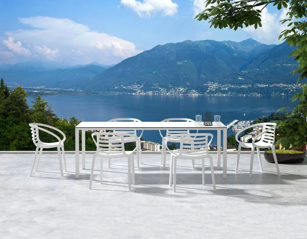 Outdoor chairs sitting around a table with a view