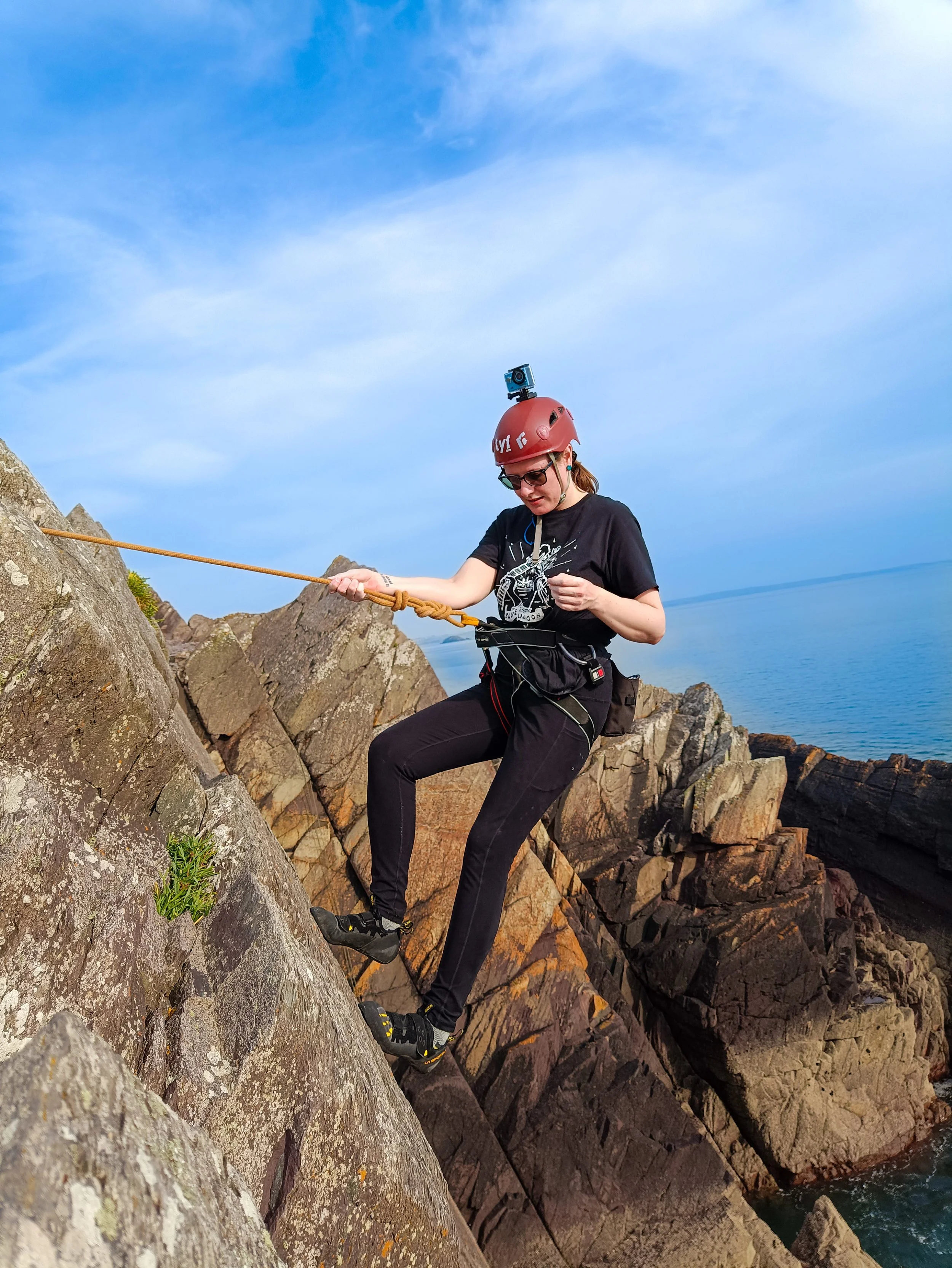 Picture of Katie rock climbing on a sea cliff