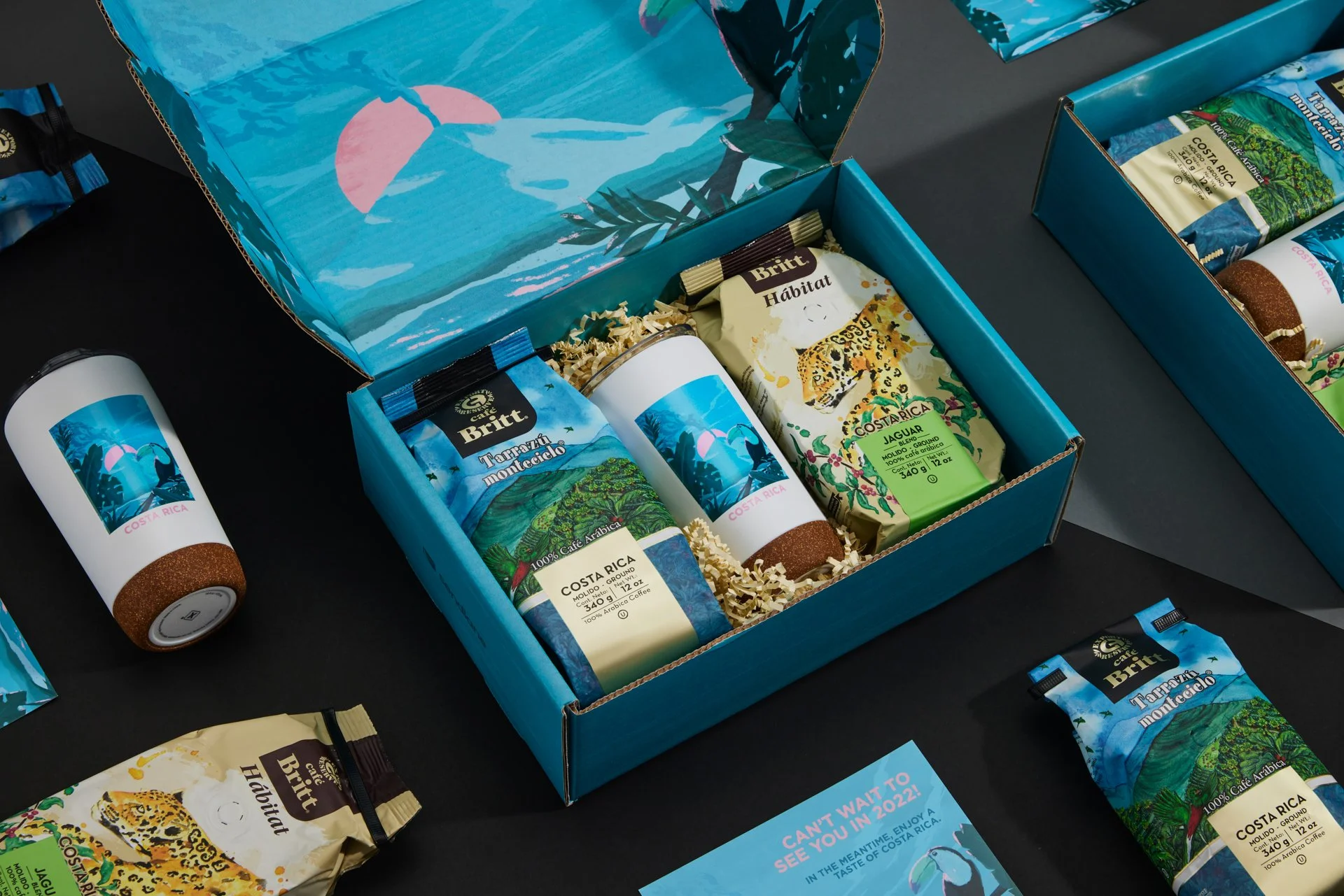 Coffee gift box with coffee bags, travel tumbler, and promotional card.