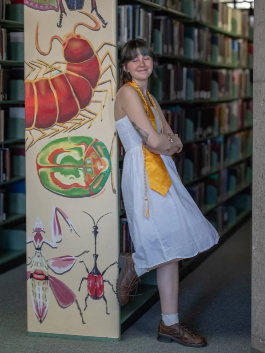 Absolutely loved taking Michelle&rsquo;s grad pictures. Some of my favorites are in front of a mural she worked on at McIntyre Library. Be sure to check it out on the 3rd floor!! #mural #gradphotos #artstudent #photography #seniorseason
