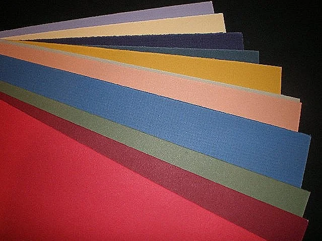 Assorted colorful sheets of construction paper in a fan arrangement.