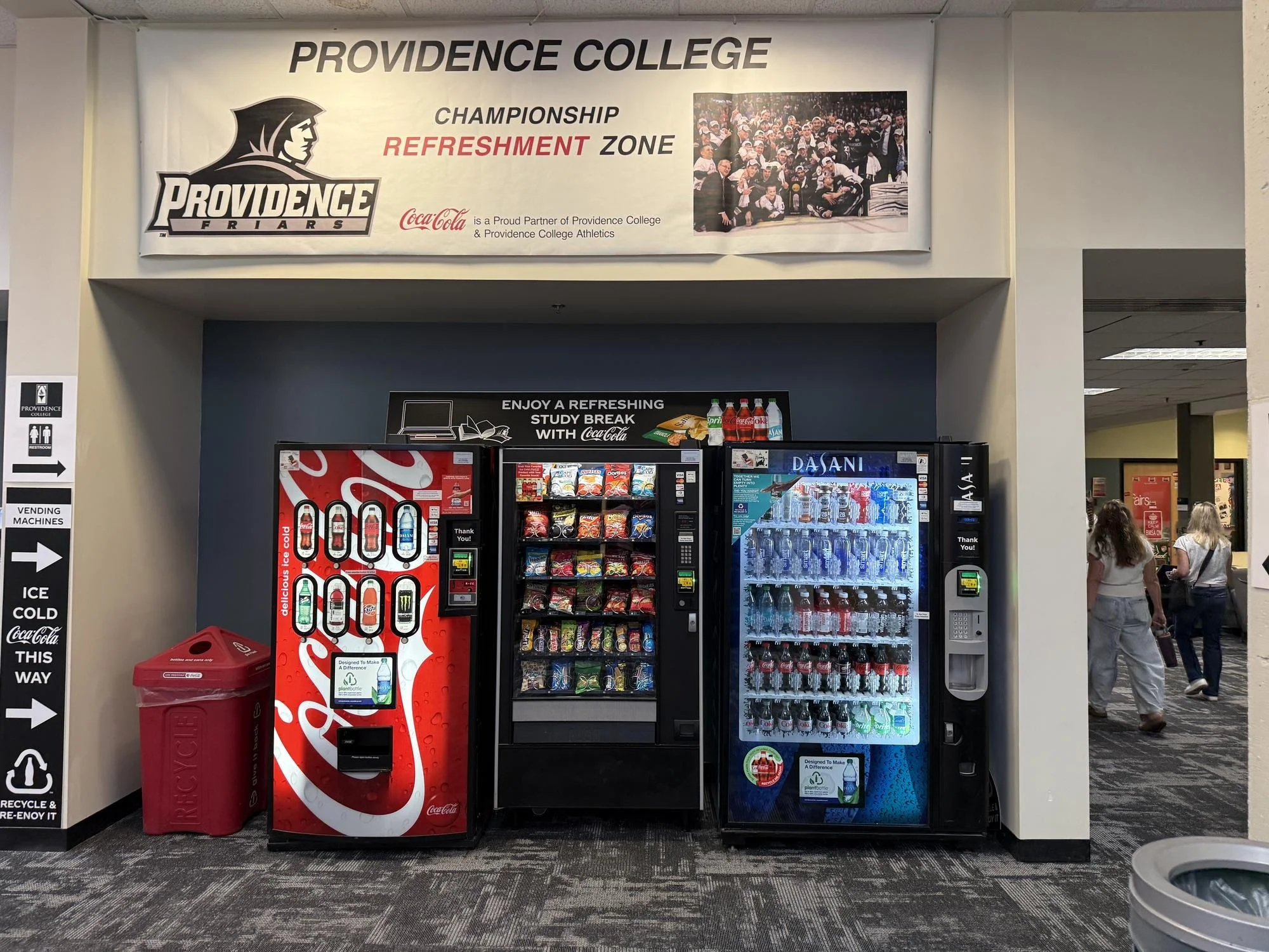 The Coca-Cola banner and vending machines