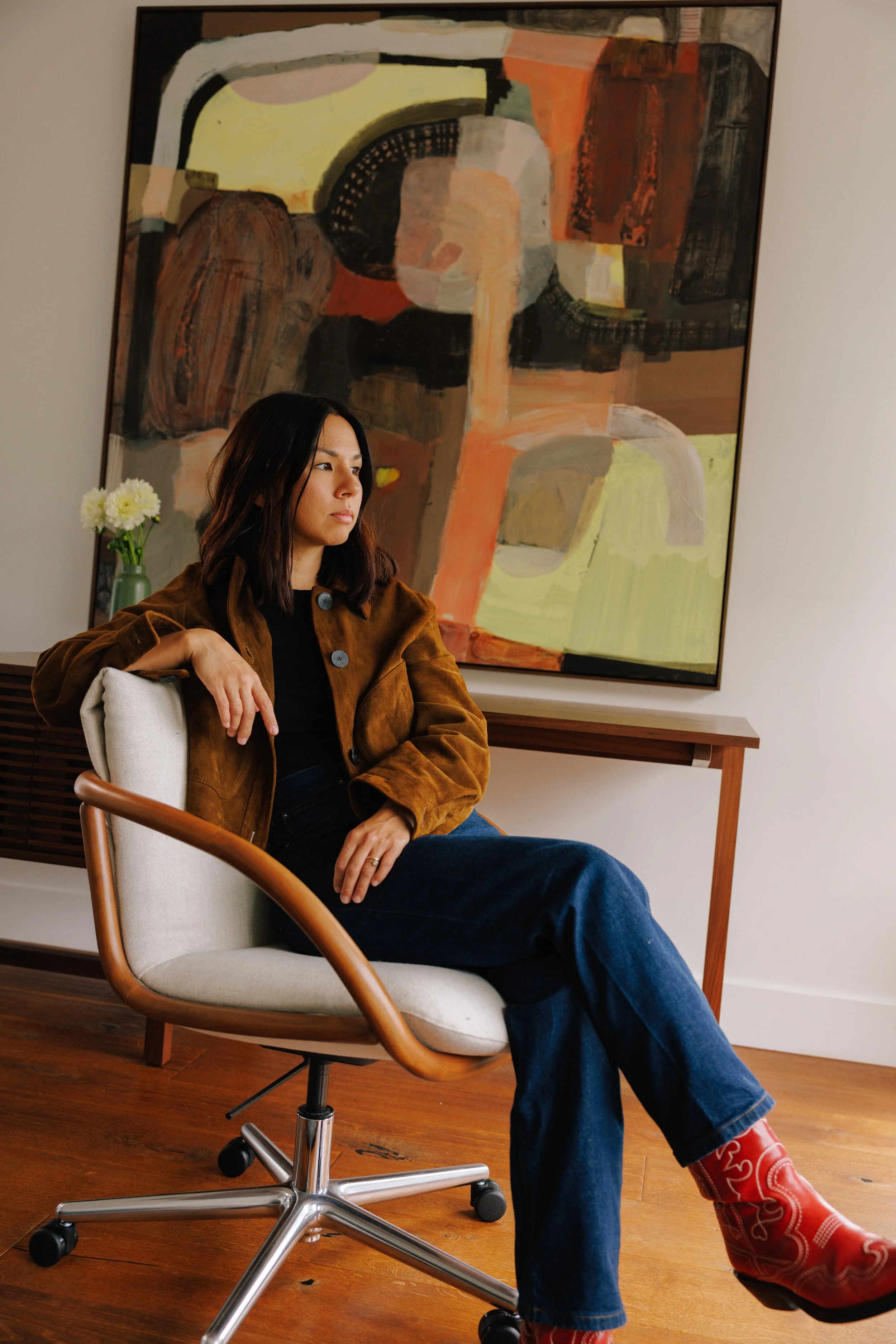 Linda Piacentini, founder and principal designer at Mura Studio, sitting in an office.