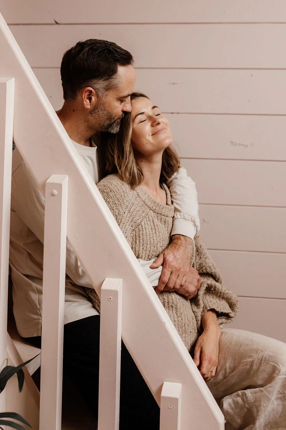 Couples photoshoot embracing on stairs