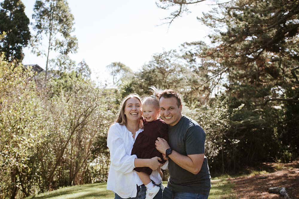 Mum dad and daughter family photo in nature