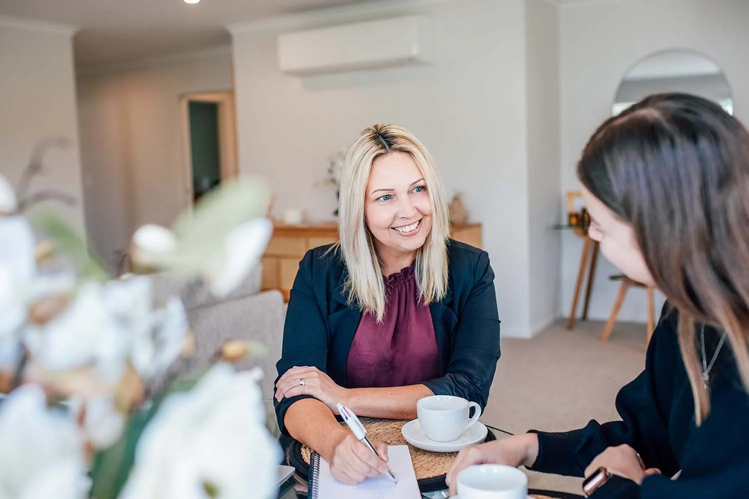 Business woman talking to client at dining table