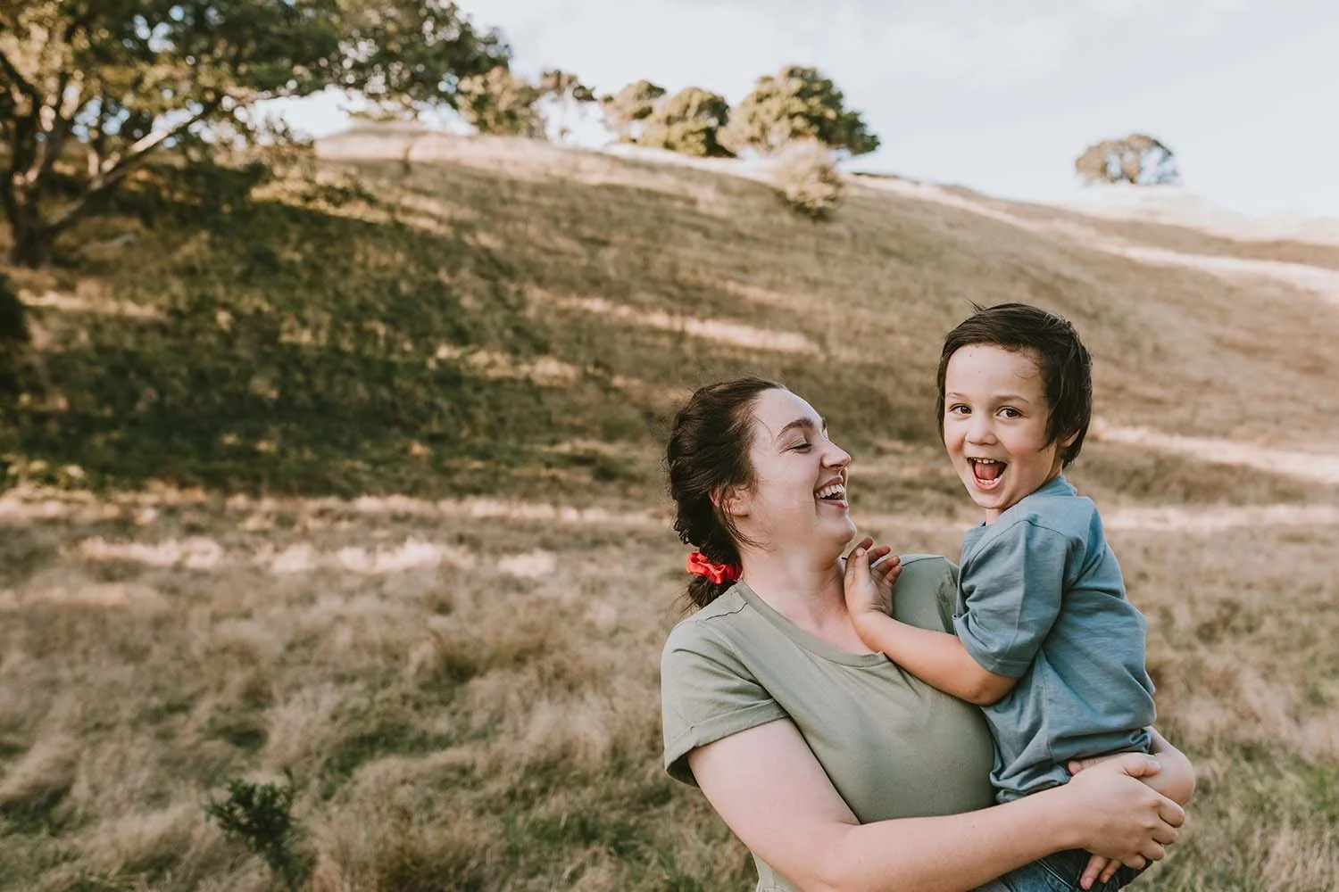 Mother and child photoshoot on grass hill 