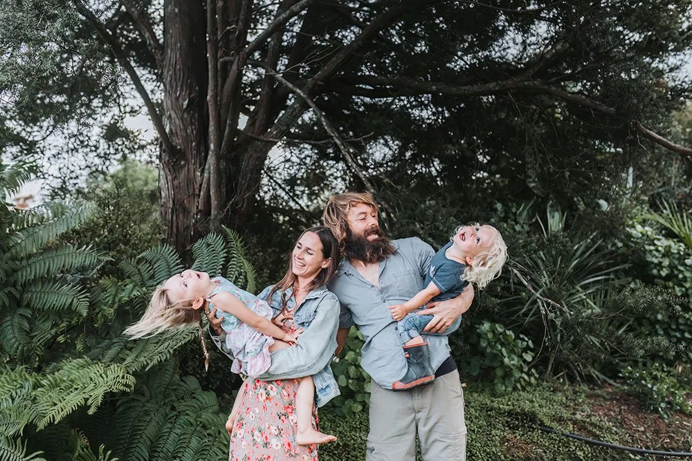Family of mother father and two kids having fun in nature