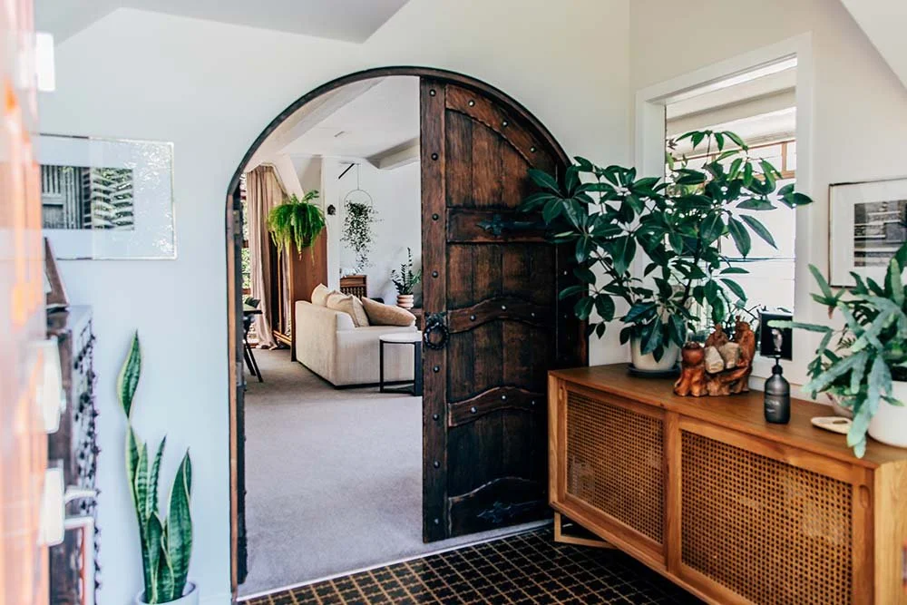 AirBnb listing image of rustic home with rounded door