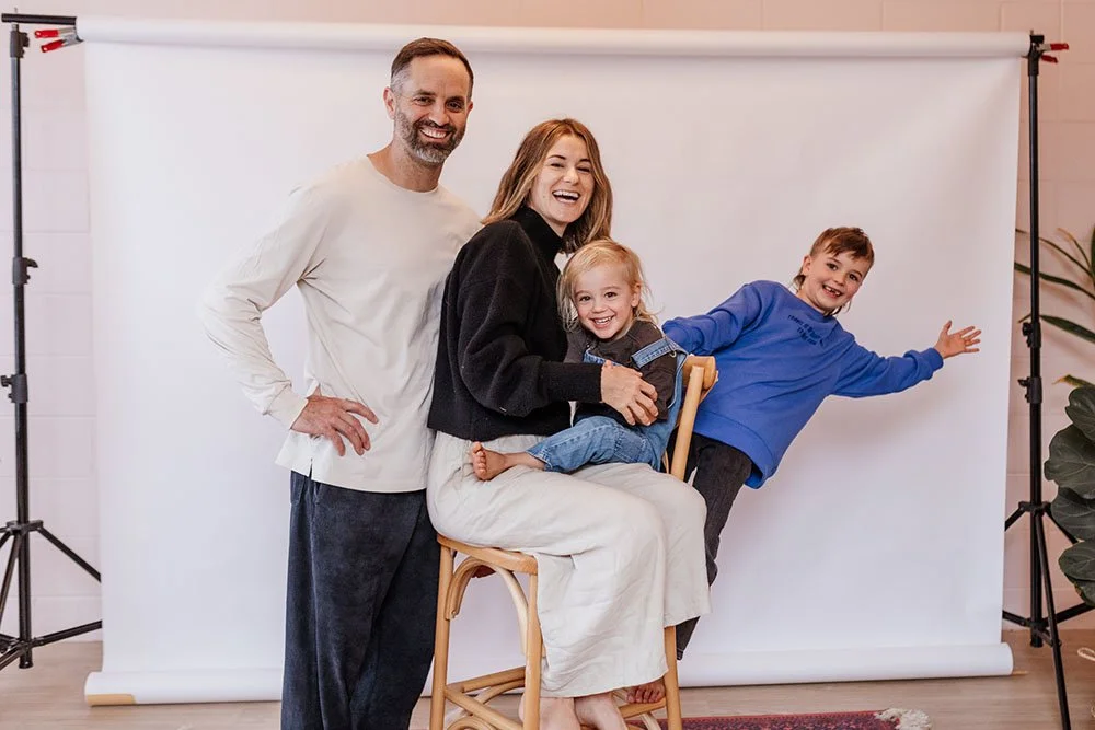 Family photoshoot with parents and kids laughing