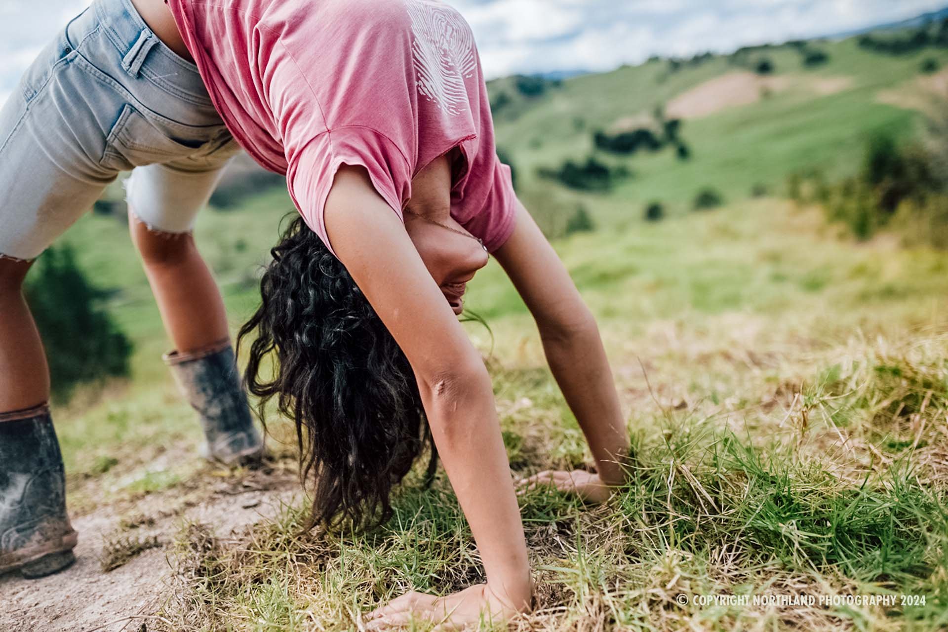 Girl on farm doing bridge. All of our images are protected by copyright and available to purchase on True Stock NZ. 