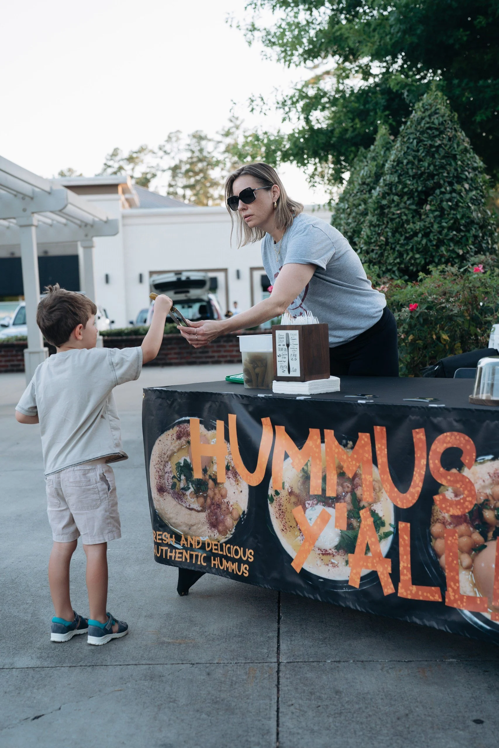Olivia to the rescue! handing over an extra pickle to our littlest foodie. This kid just discovered that extra pickles mean extra happiness!